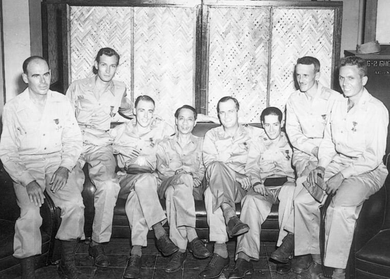 Seven American guerrilla leaders in the Philippines were presented the Distinguished Service Medal by General Douglas MacArthur. Shown from left are Major Maury McKenzie, Major Robert B. Lapham, Major Edwin P. Ramsey, General Manuel A. Roxas, Lieutenant Colonel Bernard L. Anderson, Captain Ray C. Hunt, Major John Boone, and Captain Alvin J. Farretta.