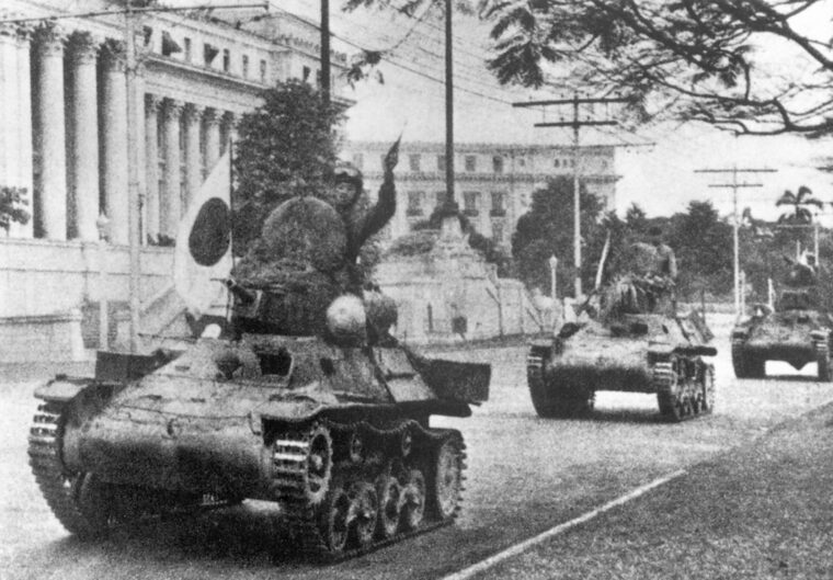 On January 2, 1942, light tanks of the victorious Japanese Army rumble along the streets of Manila past the building that houses the Philippine Legislature. After the fall of Bataan and the fortress island of Corregidor, the Japanese declared victory in the Philippines, but they were continually harrassed by American and Filipino guerrillas who chose to continue fighting rather than surrender. 