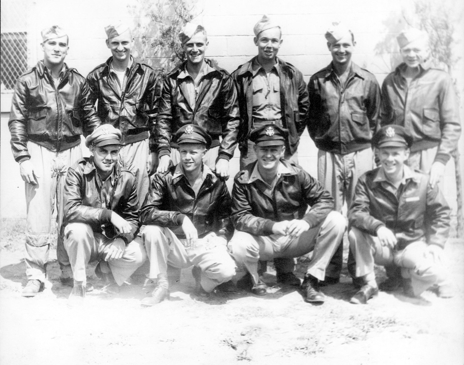 Hugh Hunter Hardwicke, Jr., and the crew of the B-17 Flying Fortress named “Uninvited” pose during a relaxation period. Uninvited and its crew were attached to the 568th Squadron of the 390th Bombardment Group. On the front row (left to right) are 2nd Lt. Gordon R. (Flick) Flickema, co-pilot (Cleveland, Ohio); 1st Lt. Hugh H. Hardwicke, Jr., pilot (Richmond, Va.); 2nd Lt. Charles (Chick) Papousek, bombardier (Chicago, Ill.); and 2nd Lt. Moody S. (Jack) Jackson, Jr., navigator (Houston, Texas). Standing (left to right) are Staff Sgt. John H. Hammond, waist gunner/armorer (Baltimore, Md.); Staff Sgt. Thomas F. Downham, ball turret gunner/assistant radio operator (Detroit, Mich.); Staff Sgt. John R. McCaw, waist gunner; Tech. Sgt. Wayman O. Avery, top turret gunner/engineer (San Francisco, Calif.); Staff Sgt. Denver L. (Pappy) Grogg, tail gunner/assistant armorer (Richmond, Ind.); and Tech. Sgt. Howard D. (Dale) Weaver, radio operator/gunner (Royalty, Texas). After Eighth Air Force bomber crews were reduced to nine in early July 1944, McCaw was transferred to another unit and did not fly combat with Hardwicke.