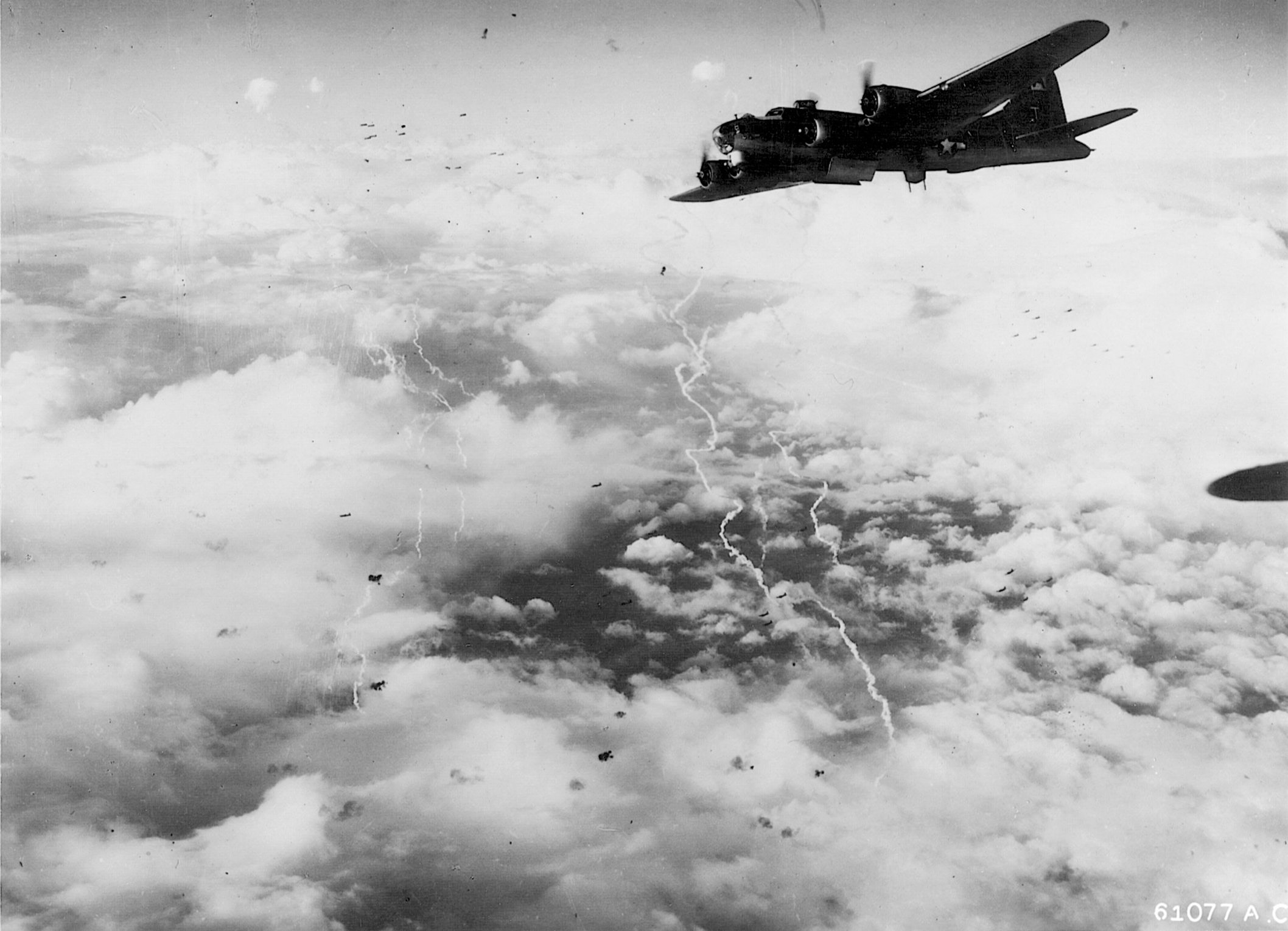 A B-17 endures heavy flak and cloud cover during a hazardous bomb run over Merseburg. Prior to their 26th mission on November 30, 1944, Pilot Hugh Hardwicke and the crew of Uninvited had already flown one mission to the heavily defended target. 