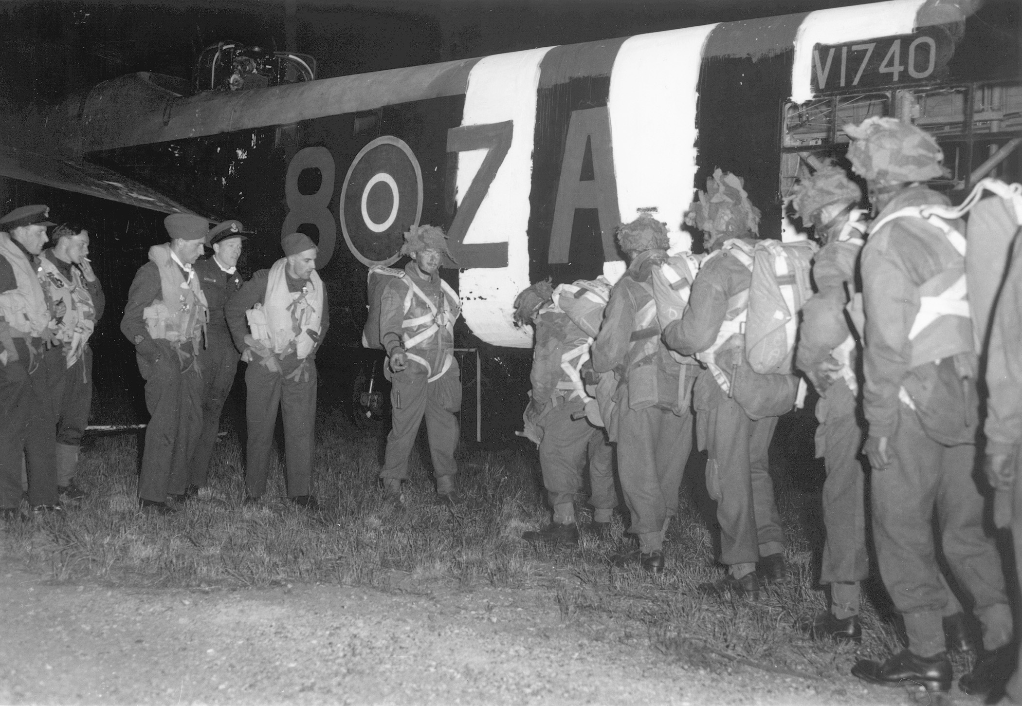 Paras begin boarding a converted RAF Albemarle bomber. Men of the first wave, these troops descended on the Norman countryside just after midnight on June 6, 1944. Invasion stripes, painted for ease of identification, are plainly visible on the aircraft’s fuselage.
