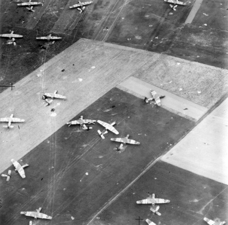 Landing Zone N is shown from above after British gliders have touched down. Collapsed parachutes, which impeded the progress of the Airborne troops when they wrapped around the wheels and tracks of vehicles, are visible. 