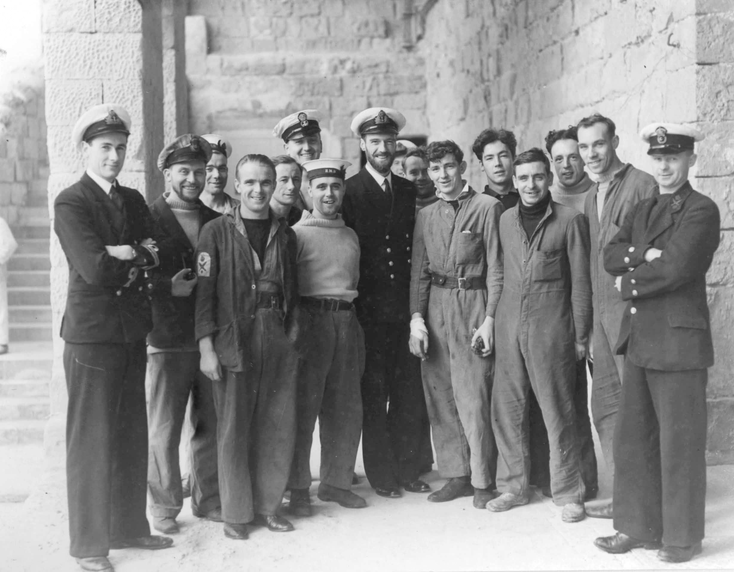 Born in India, Lt. Cmdr. Malcolm David Wanklyn was a graduate of the Royal Navy College at Dartmouth. Here, he stands (bearded, center) with Upholder’s crew at Lazaretto in late 1941.