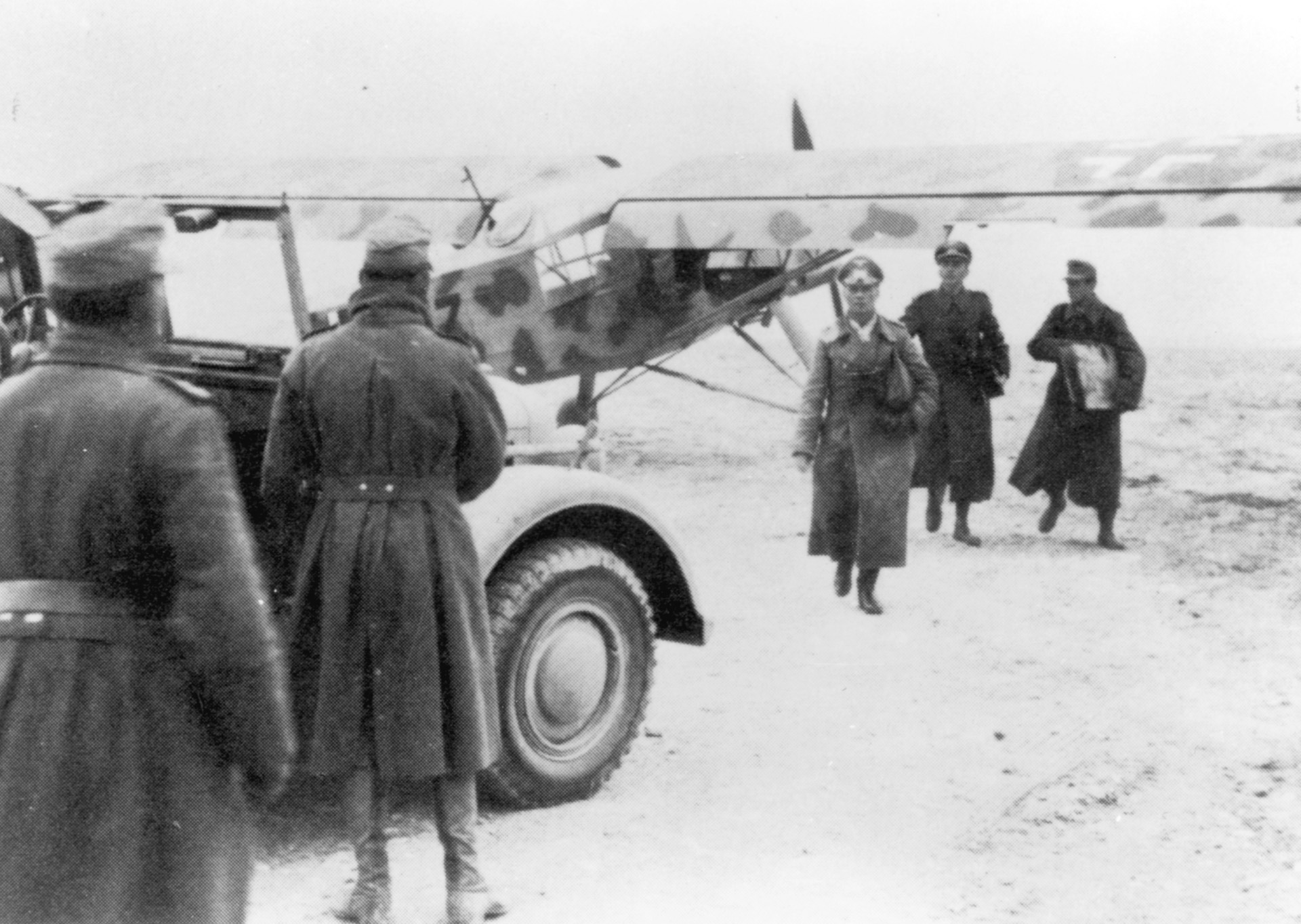 Field Marshal Rommel, followed by two aides, walks away from his command Storch. Rommel spent a great deal of time in the air and felt fortunate not to have been shot down.
