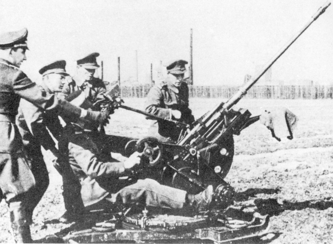 Training with a German officer, a Romanian gun crew learns to operate its weapon.