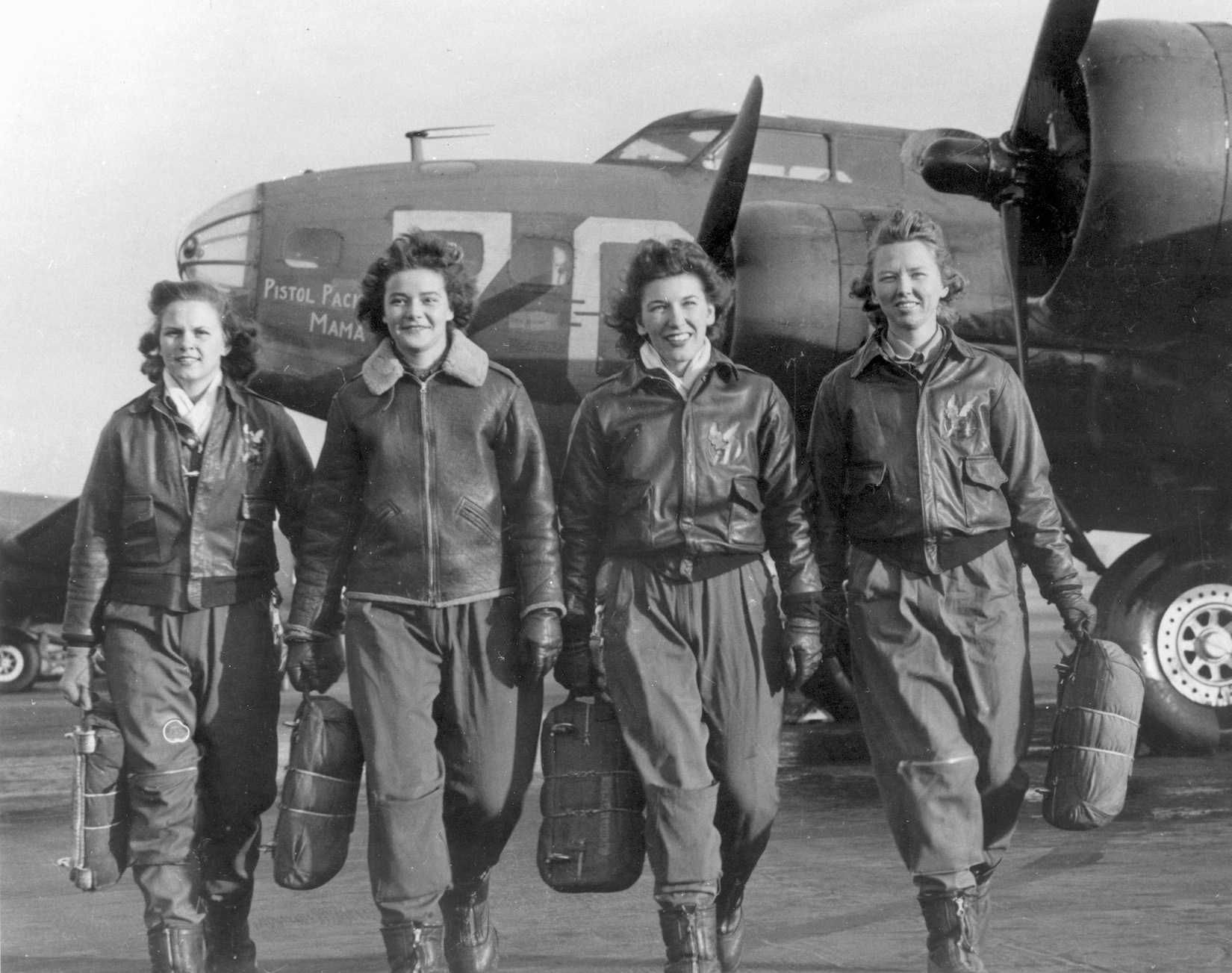Four WASPs walk away from an aircraft at Lockbourne, where they trained to ferry Boeing B-17 Flying Fortress bombers and other four-engine aircraft.