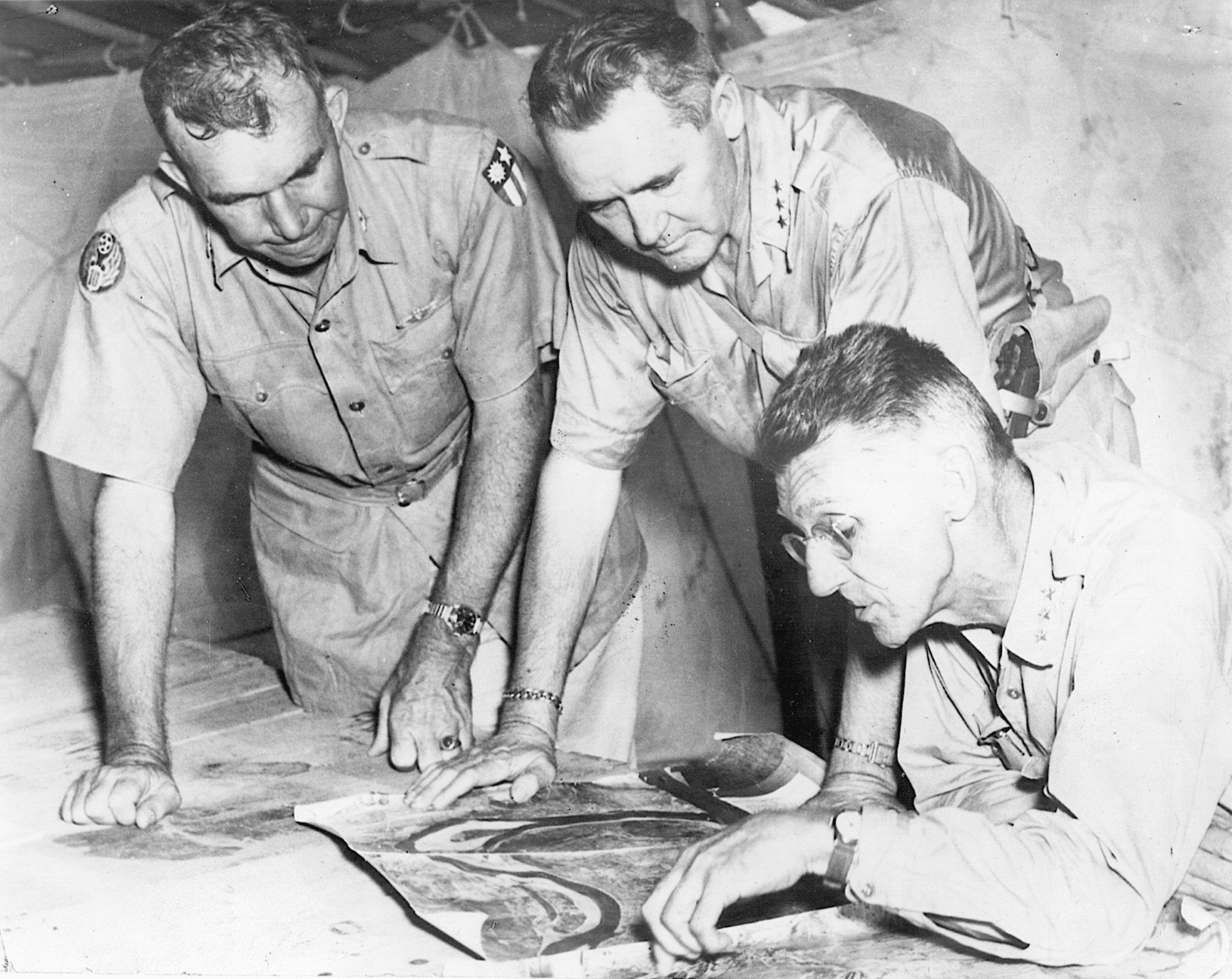 Stilwell (seated) plots strategy for a 1944 offensive in Burma with Generals Barney M. Giles (center) and Howard C. Davidson.
