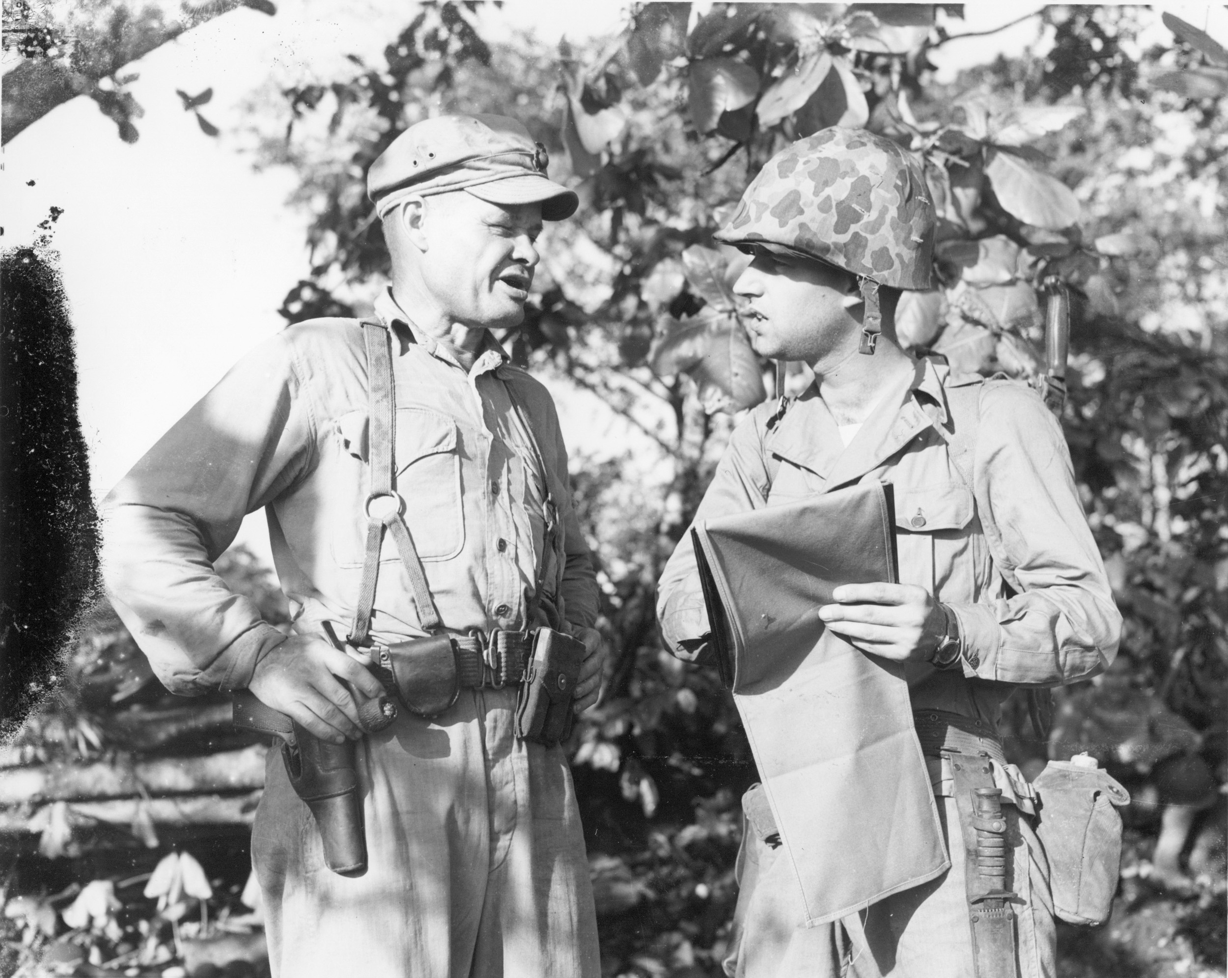 An ever-present figure near the front line, Chesty Puller (left) discusses troop dispositions with another officer.