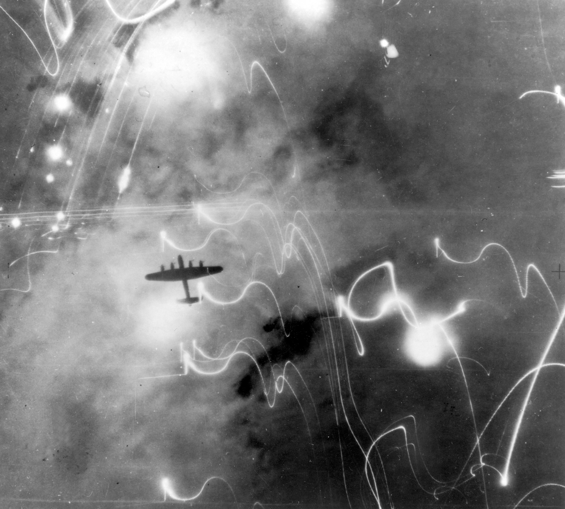 Smoke, flames, and antiaircraft fire silhouette a British Avro Lancaster bomber during a January 30, 1943, raid on the German city of Hamburg. In July 1943, Allied bombing raids created a 
devastating firestorm in Hamburg that burned and suffocated thousands of people.