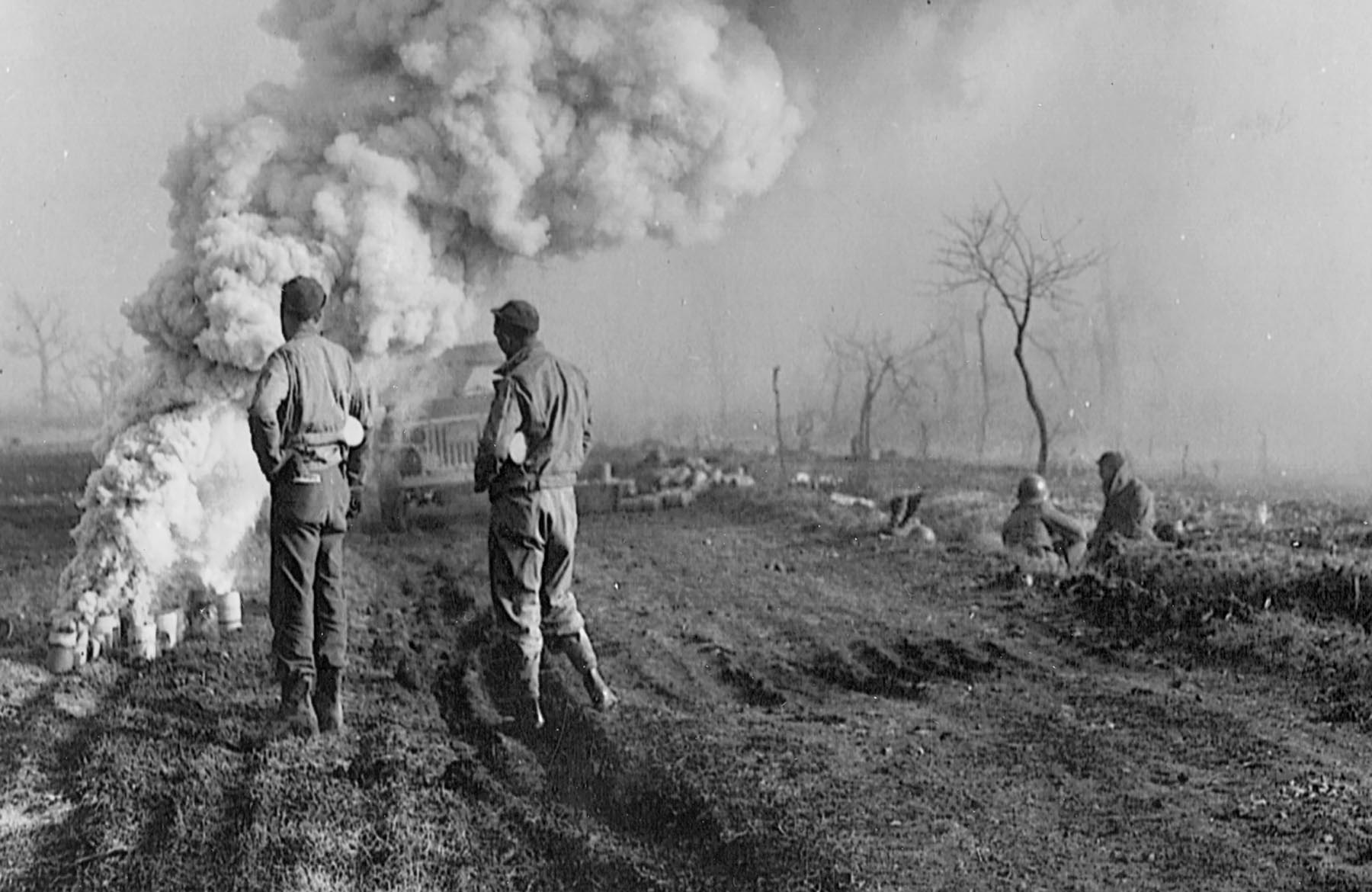 Soldiers of the 36th Division watch as smoke they have ignited boils skyward in an attempt to mask the advance of two regiments toward the Rapido River.