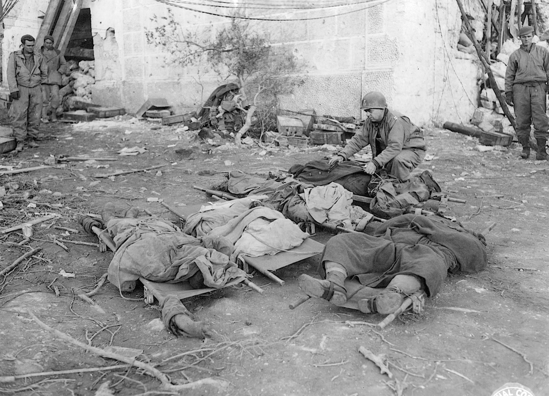 Following the bitter battle at San Pietro, 36th Division Chaplain Robert E. Alspaugh evacuates the bodies of T-patchers killed in action.