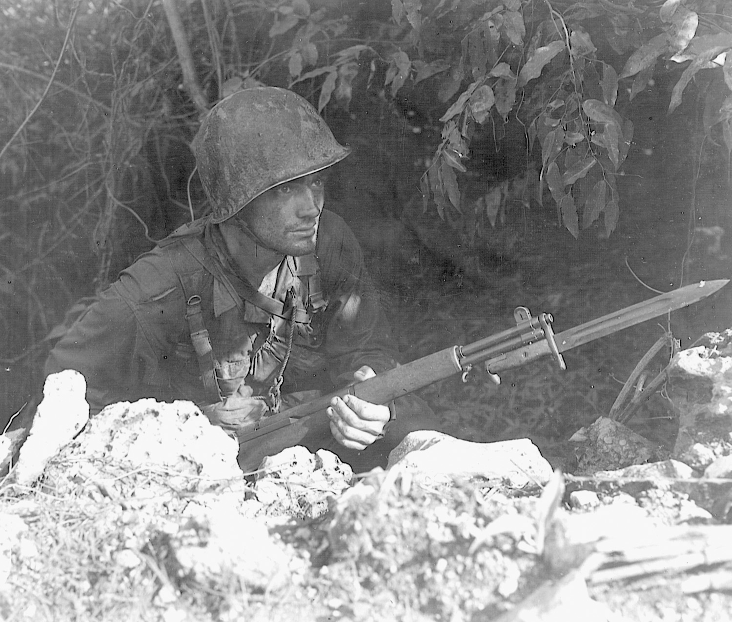 Staying alert, a soldier of the U.S. Army’s 27th Infantry Division watches for Japanese snipers.