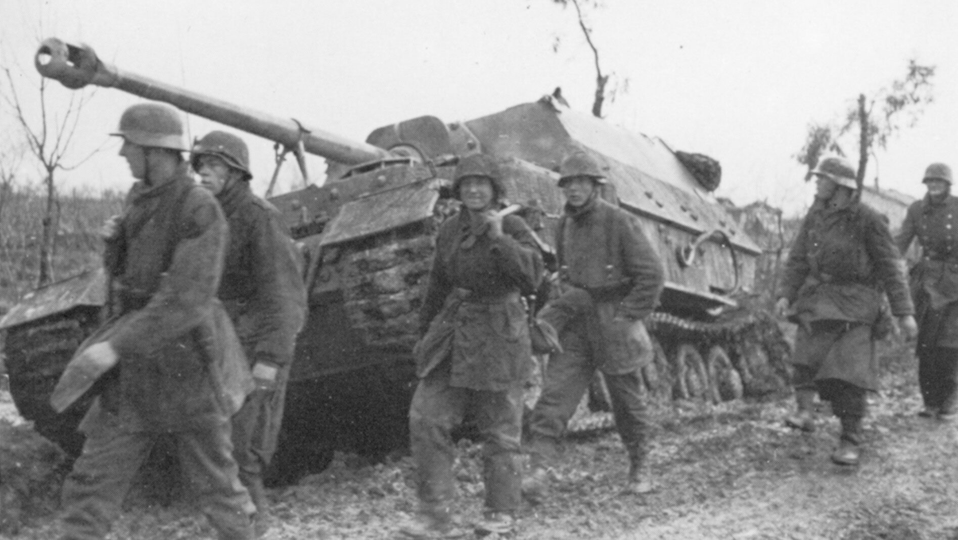 German panzergrenadiers move past an idled Ferdinand self-propelled assault gun on a roadside near the Italian town of Nettuno in March 1944.