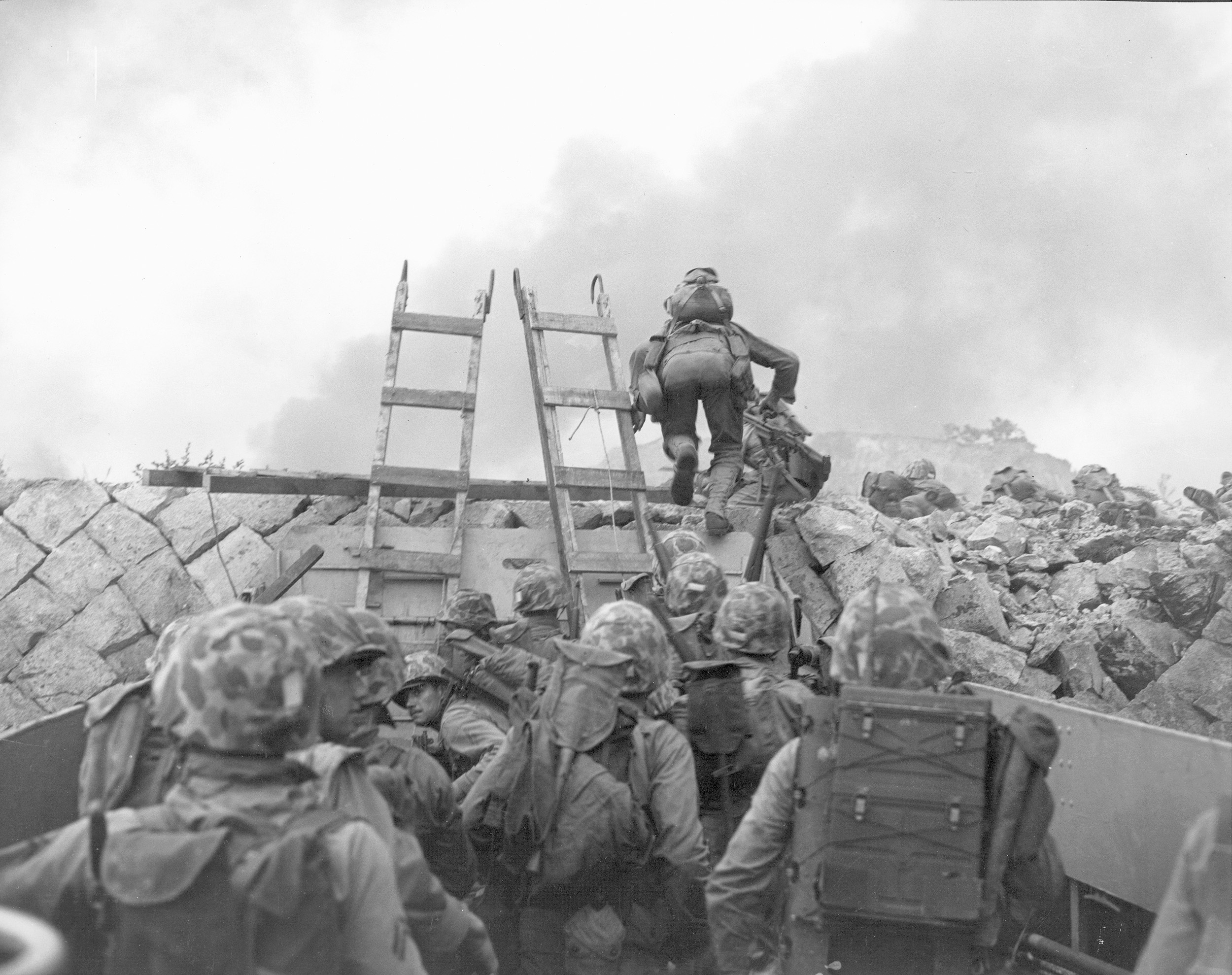 Marines use an ancient implement, scaling ladders, to climb the seawall at the harbor at Inchon.  Their attack was so swift and successive waves so well-timed that casualties were low.