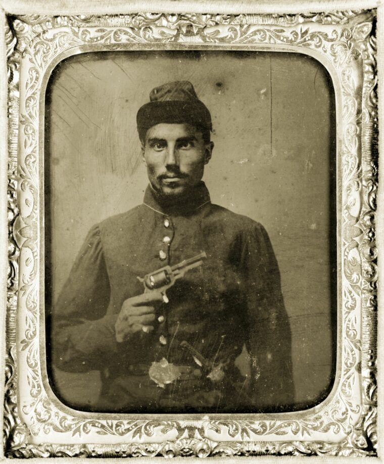 Black Union soldier proudly flourishing his pistol.