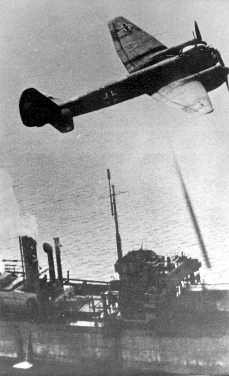 A Ju-88 flying a mast height over the merchantman Paulos Potter.