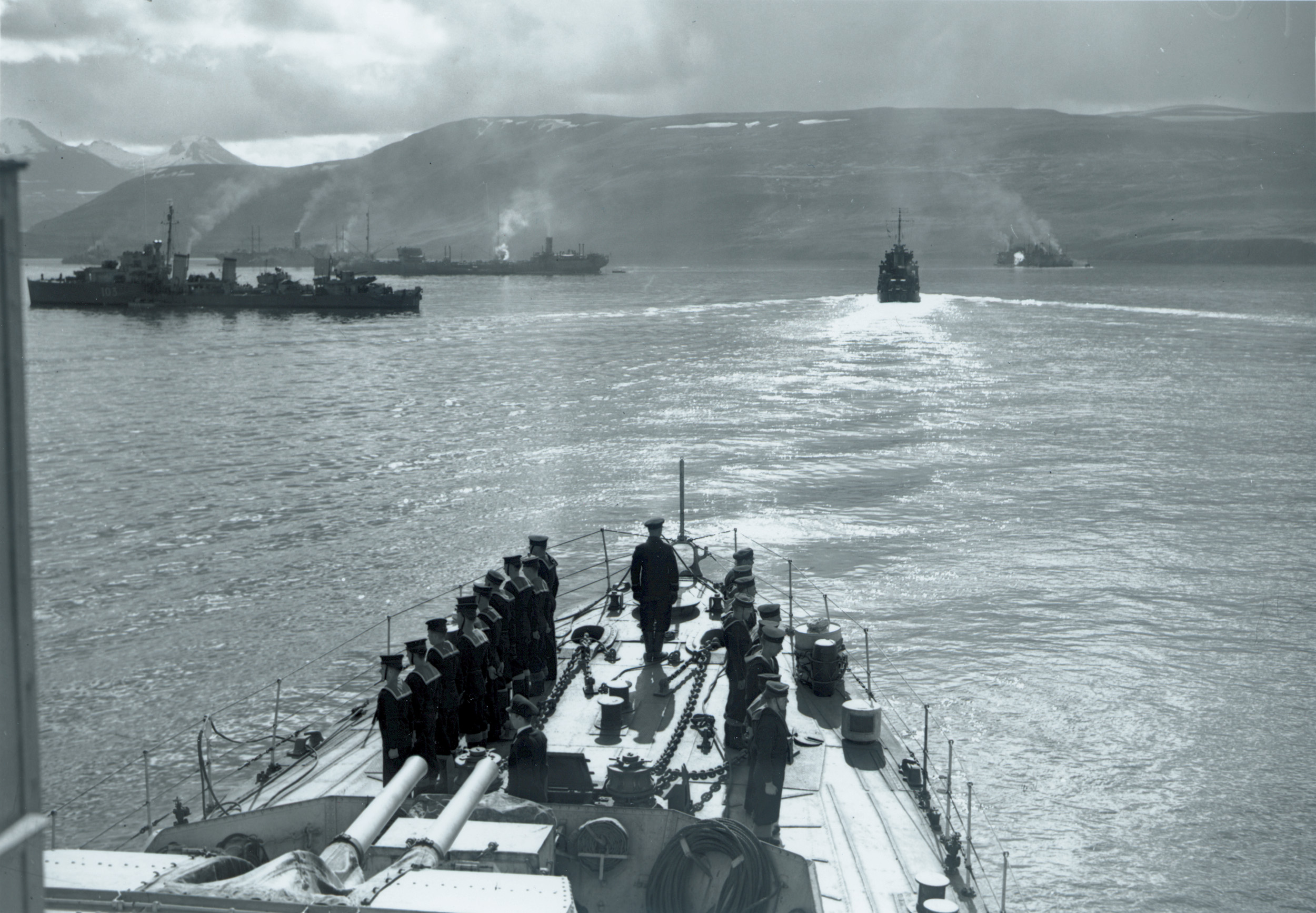 Allied destroyers and merchant ships gather in a fjord in  Iceland in June to assemble the convoy.  Visible are British destroyers and Soviet tankers.