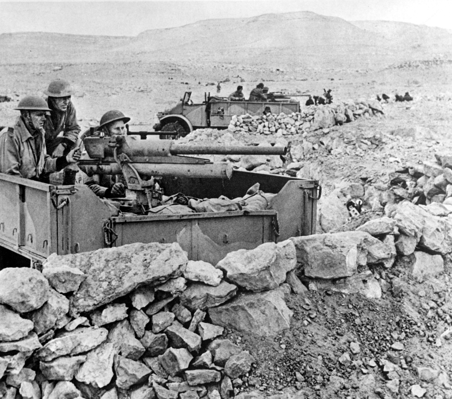 British gunners, protected behind a parapet of stones, prepare to engage Rommel’s panzers with a captured Italian 47mm anti-tank gun.