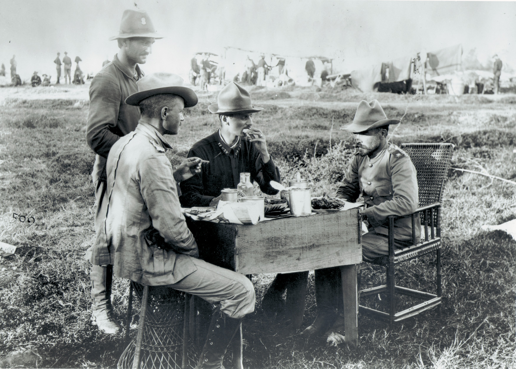 Funston takes a meal with his Kansas National Guardsmen in the field during the Philippine Insurrection.  The future general is on the  right, his small stature in evidence.