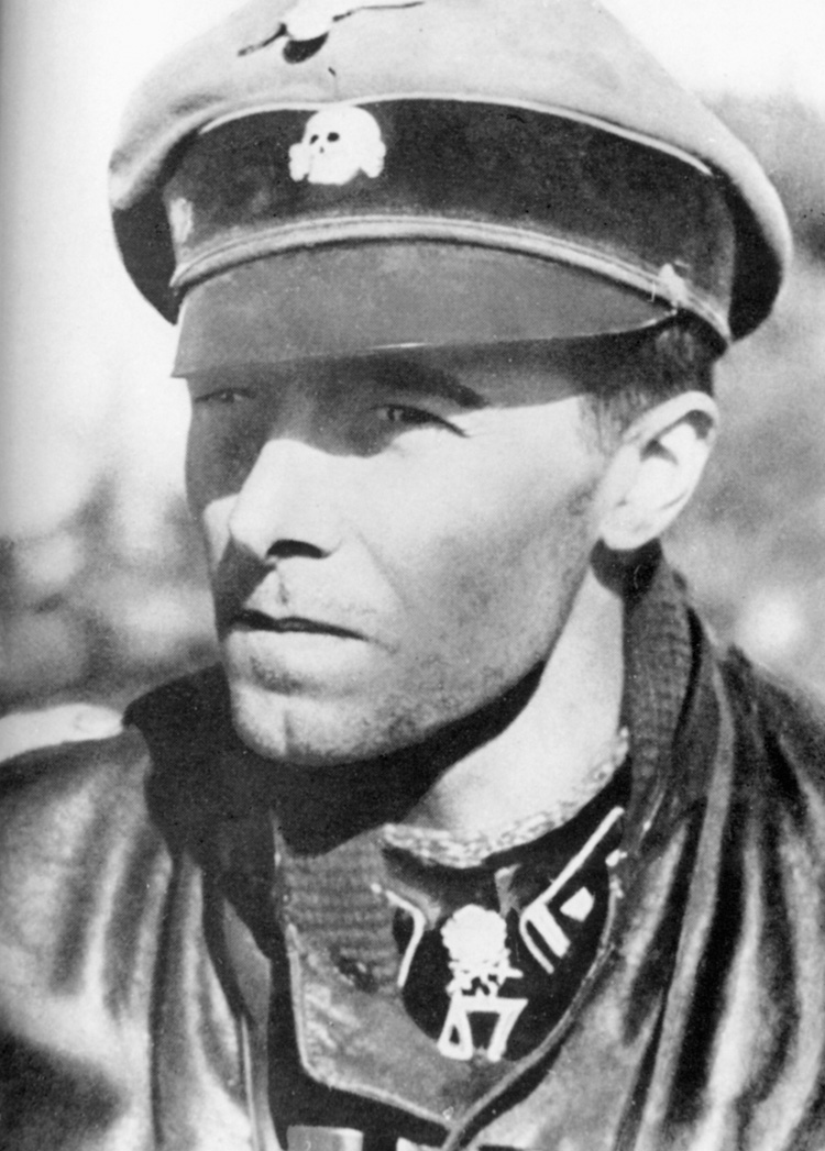 The Knights Cross with oak leaves and swords hangs from the neck of SS Lt. Col. Jochen Peiper, who was tried as a war criminal for his actions during the Battle of the Bulge.