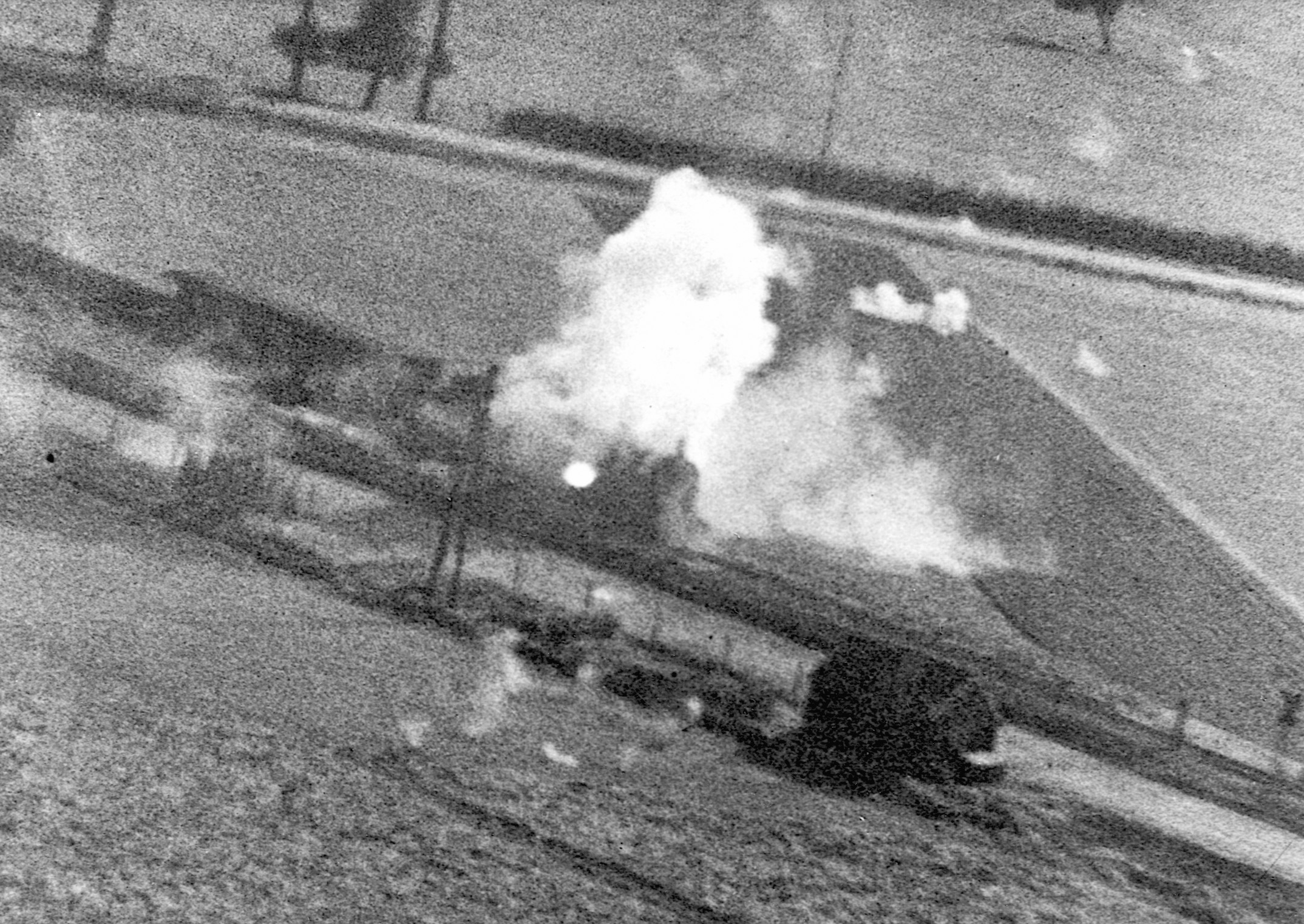 A train engine explodes after being fired on by U.S. fighter planes.