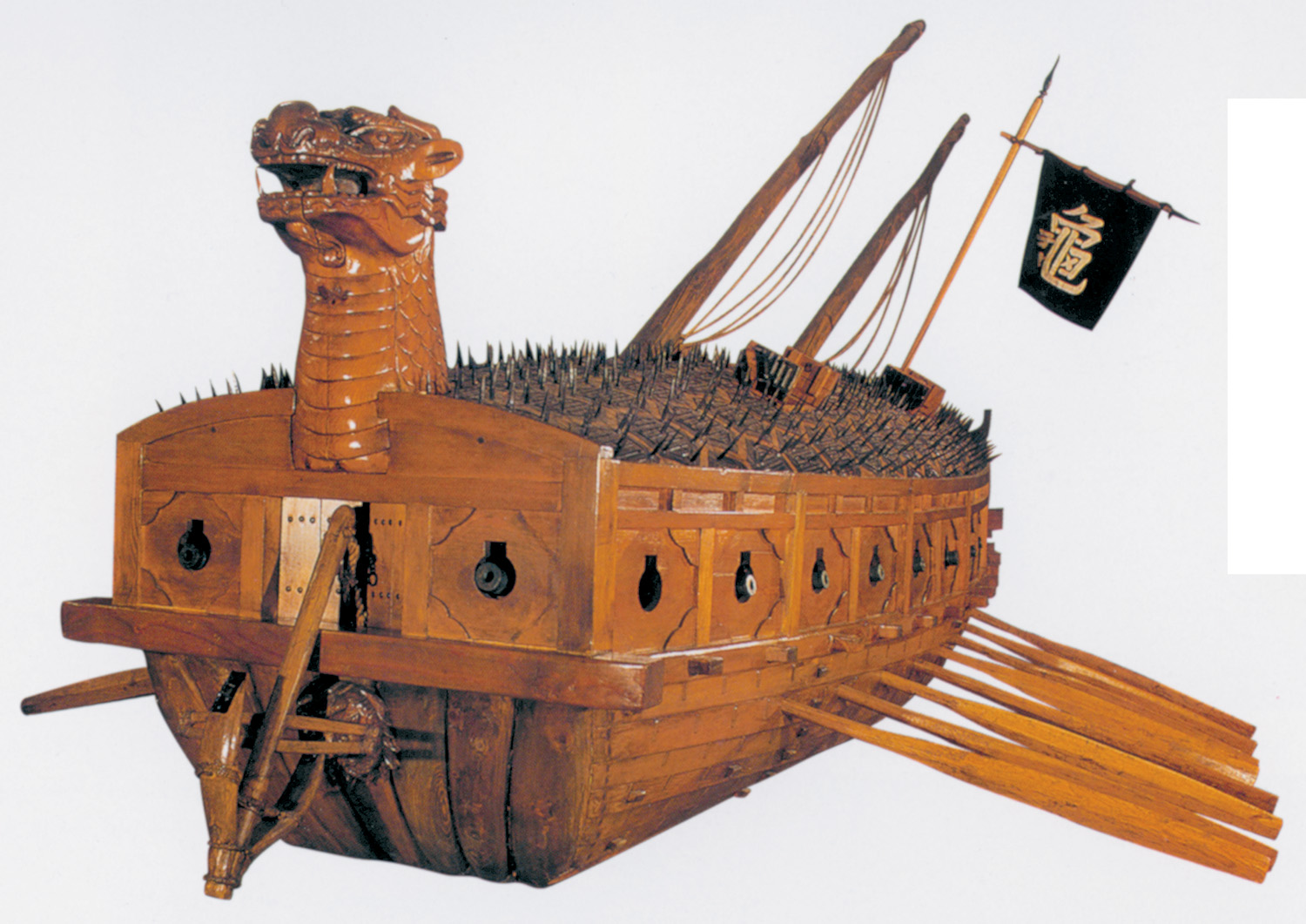 A model of the turtleship. Recent scholarship suggests the dragon head was lower, and could be pulled inside after firing a cannon between its jaws.