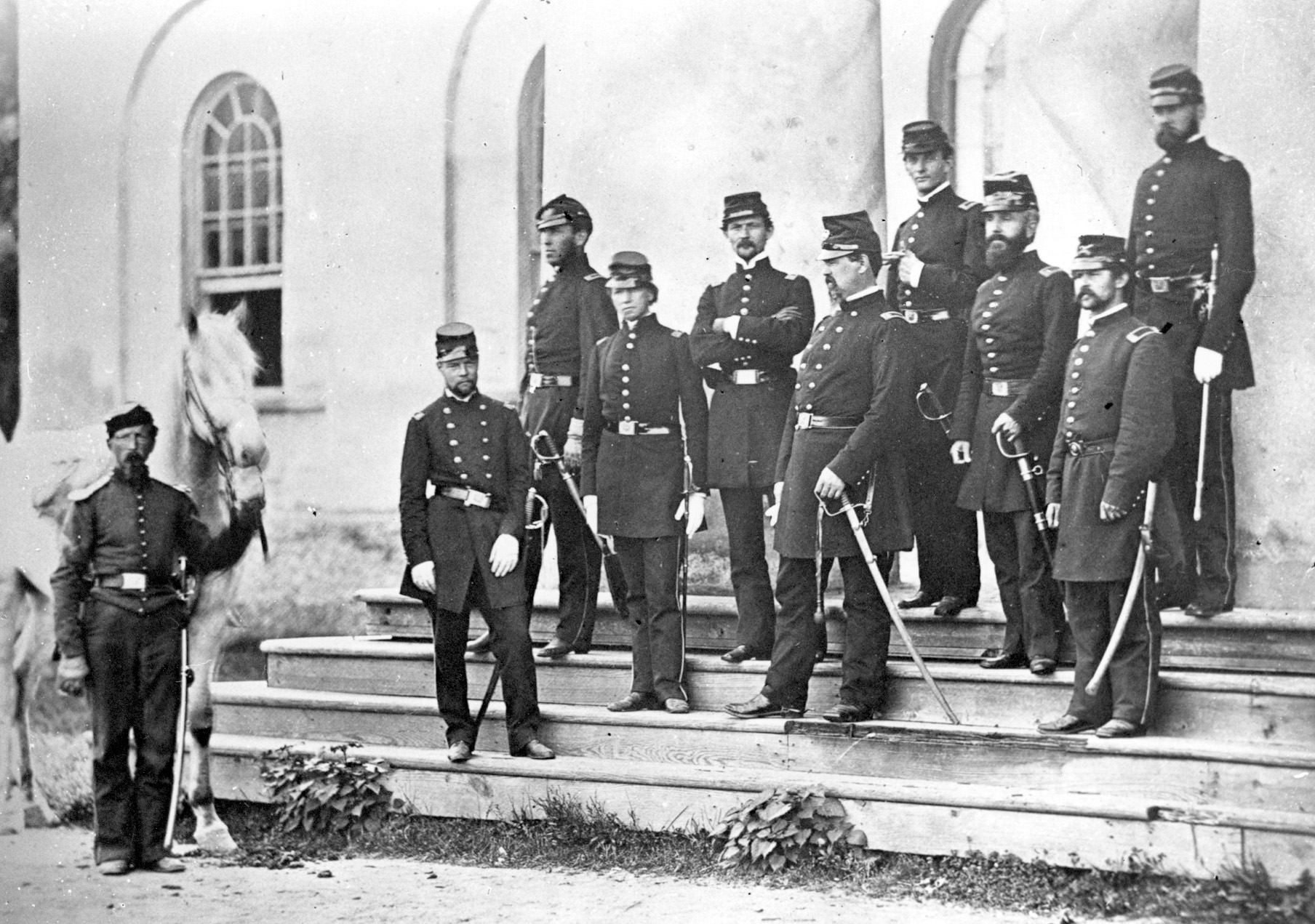 General McDowell, hand on sword at center, poses with his staff on the steps of Robert E. Lee’s former Arlington, Va., home.