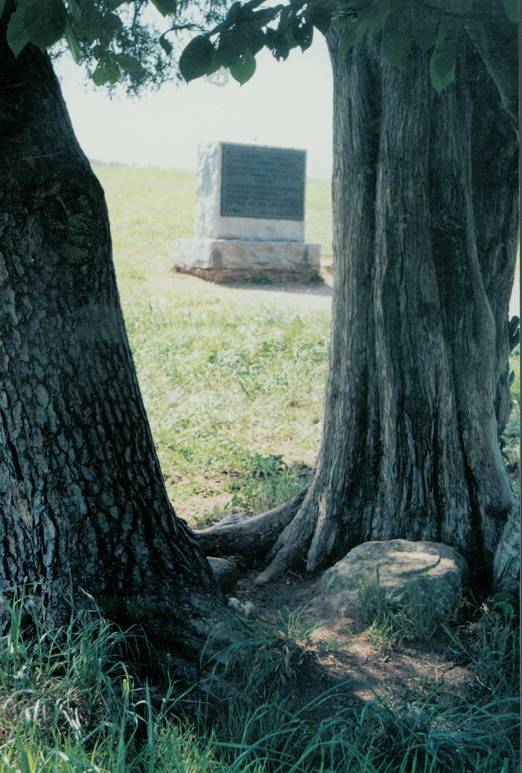 The base of the 1861 monument to Col. Bartow can be seen by the roots of a cedar tree on the battlefield. A few yards away is a monument to Bartow erected in 1936.