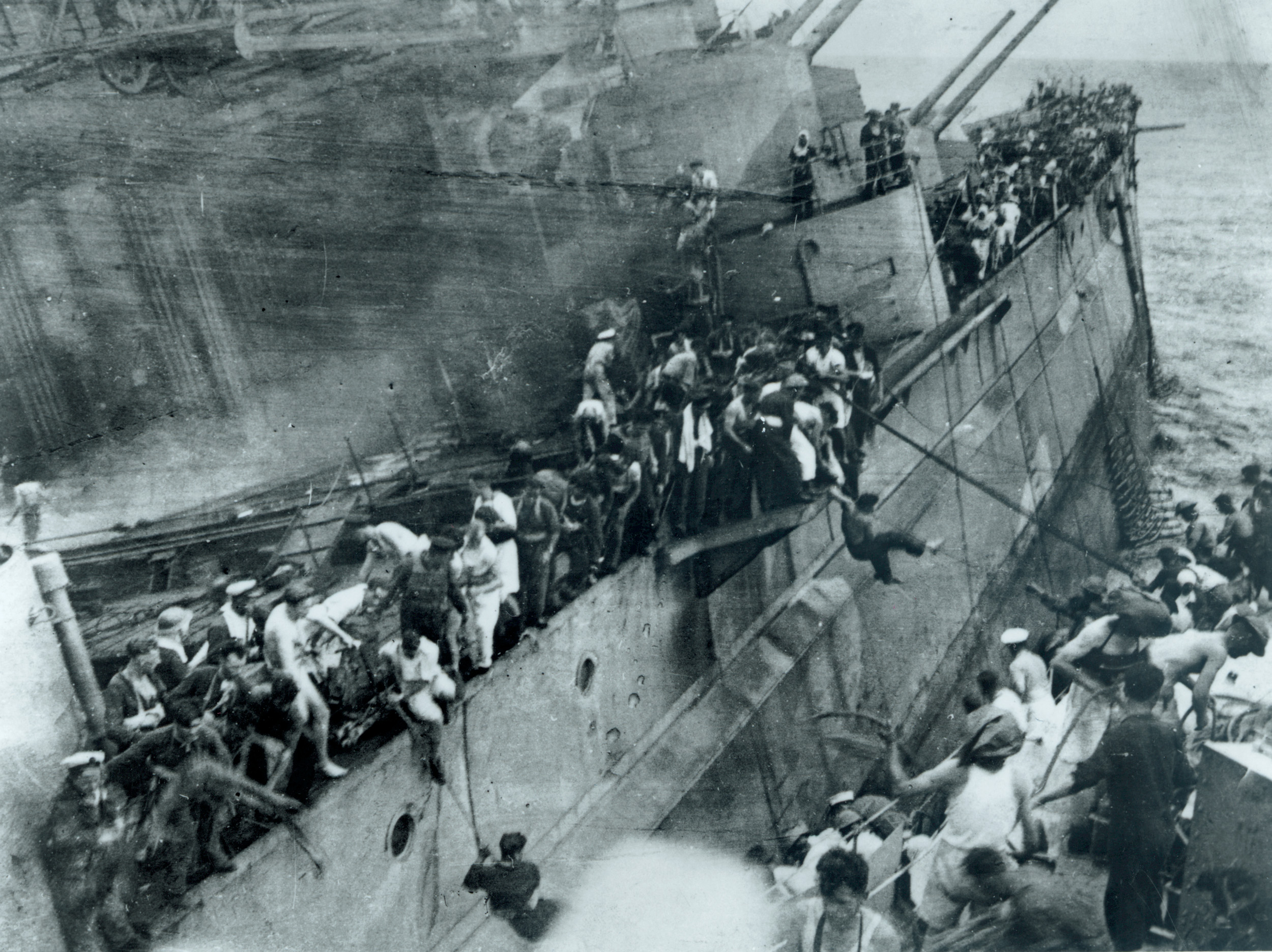 One of the crew of the destroyer Express took this photograph of crewmen of the Prince Of Wales scurrying to make the passage from the doomed ship to the valiant smaller vessel. The Express held close as long as she could. 