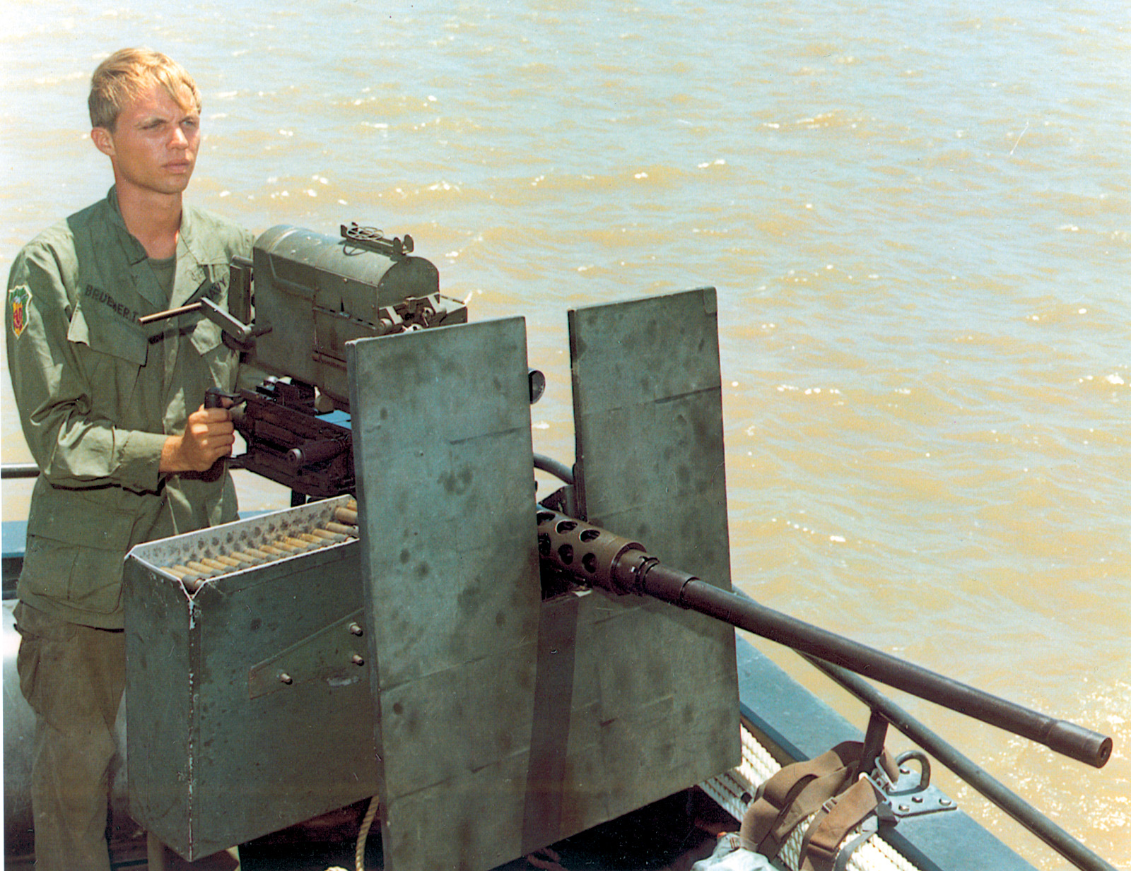An American soldier on a river in South Vietnam with a .50-caliber machine gun. The type that Browning invented early in the 20th century has seen duty in most wars since.  