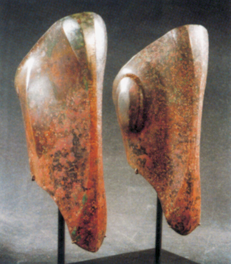 Greek bronze greaves molded to protect the shins during battle.