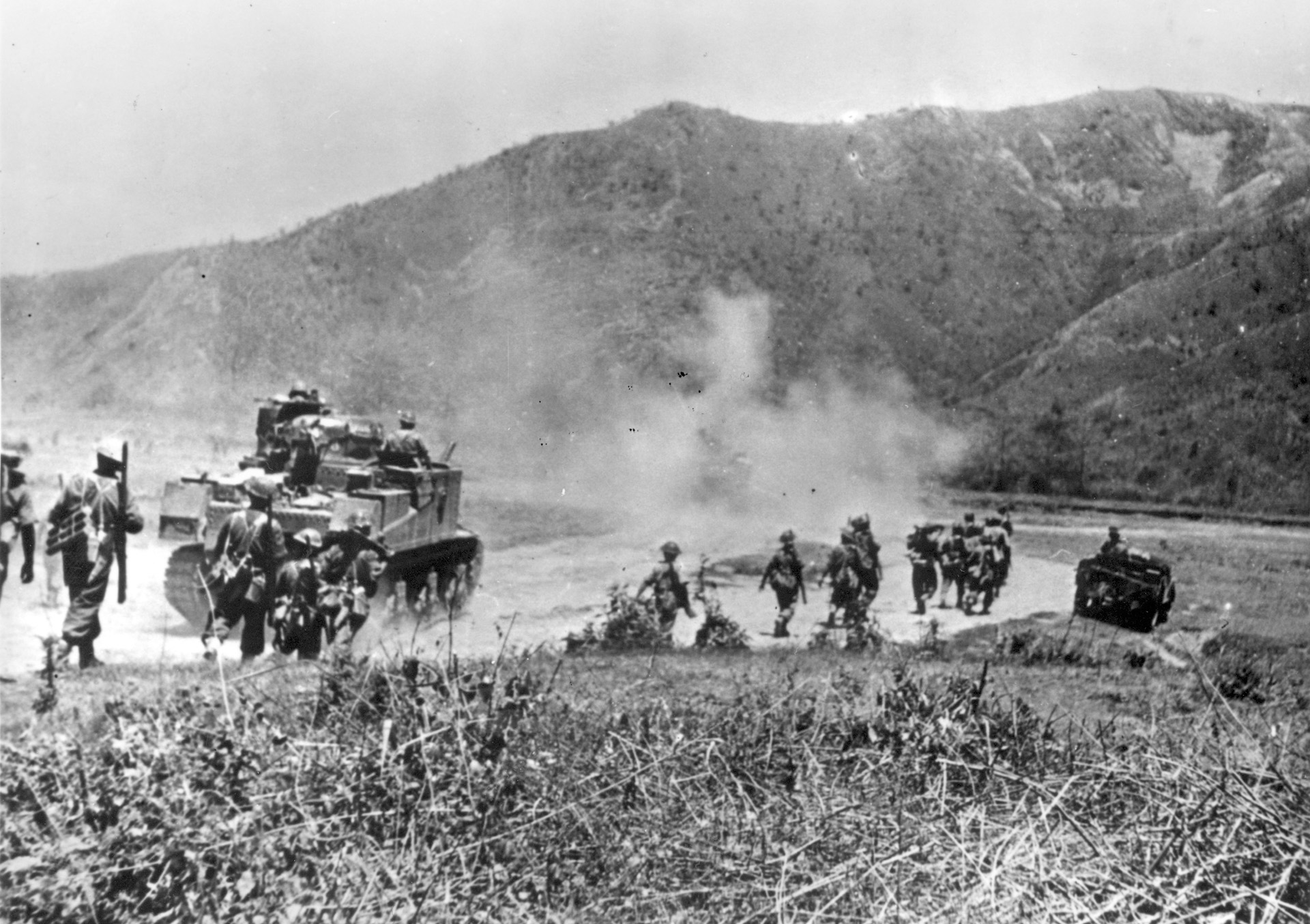 Soldiers of the West Yorkshire Regiment, along with Gurkhas, march on the Kohima-Imphal road. 