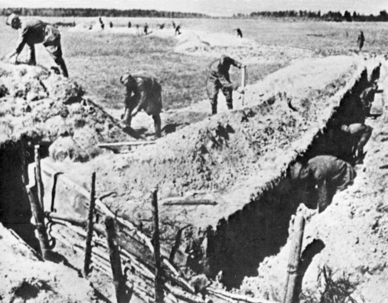 Russian soldiers near Kursk dig some of the 6,000 miles of trenches in the area. Three hundred thousand civilians also were put to work on the defenses.