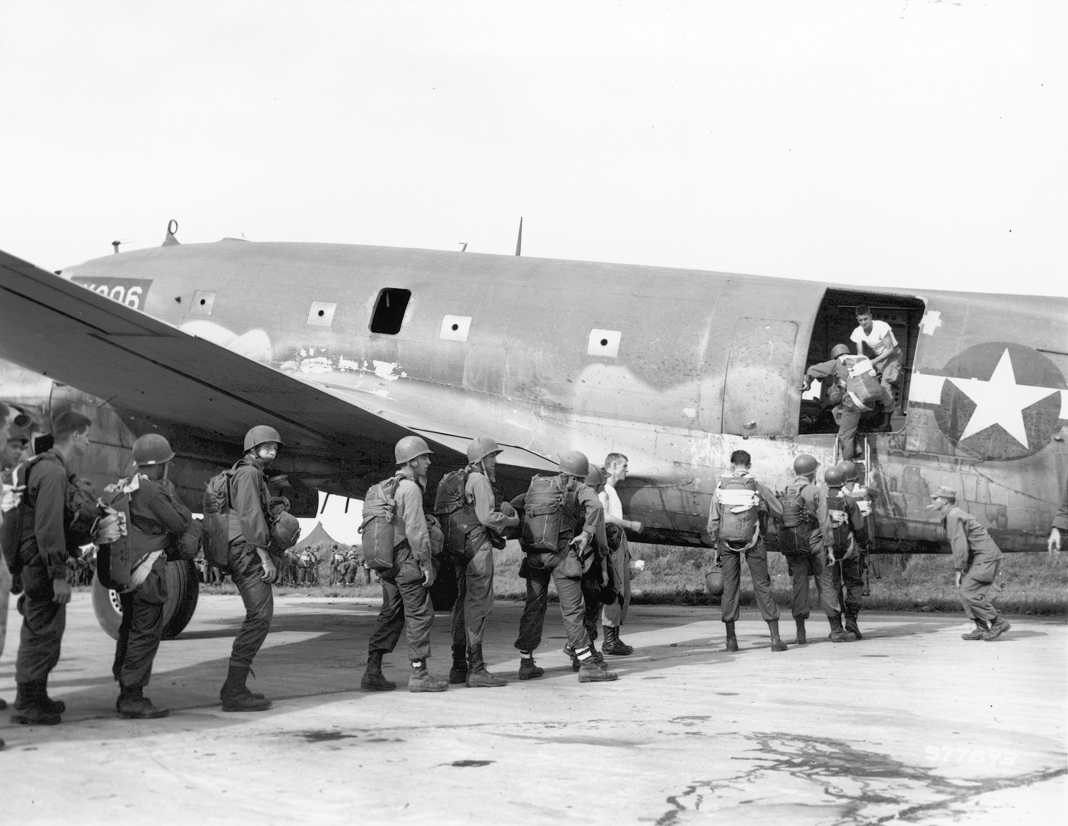 Men of the 11th Airborne board a plane for an impending jump.