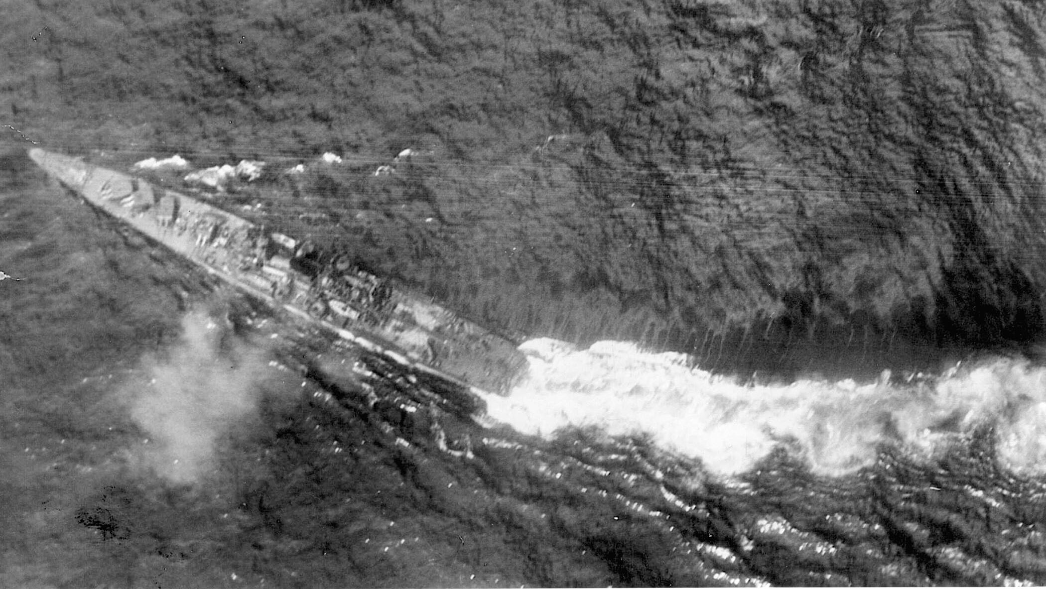 The Japanese heavy cruiser Chikuma dodges for her life in a daylight phase of the Battle of Leyte Gulf. U.S. airmen sank her. 
