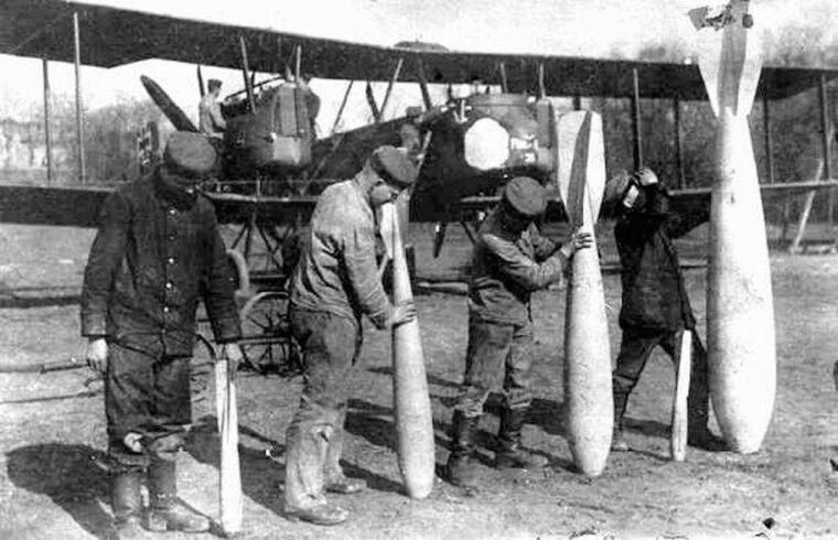 Crew display several types of Gotha bombs. The largest bombs weighed more than 100 pounds. 