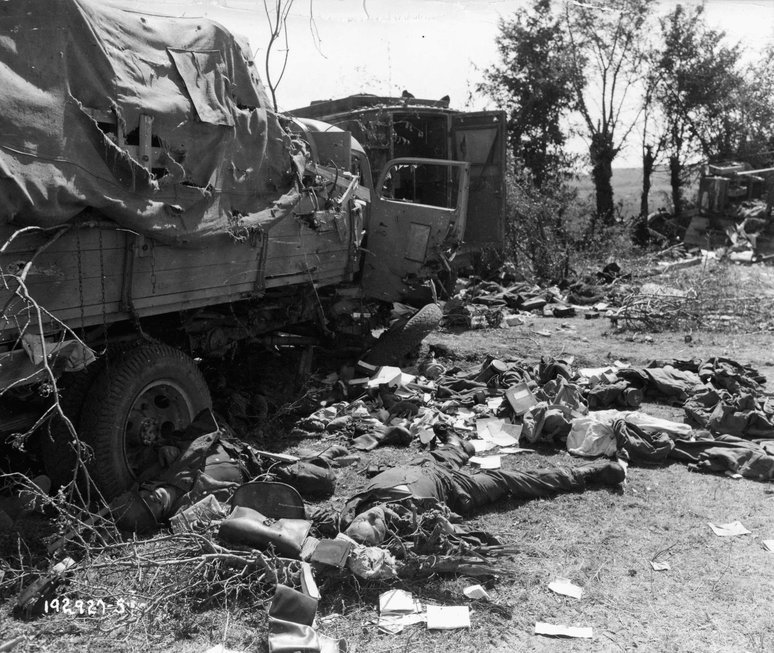 During its thwarted attempt to escape encirclement in the Falaise Pocket, this German convoy has been bombed and strafed by Allied fighters, leaving it a twisted mass of wreckage and dead bodies.