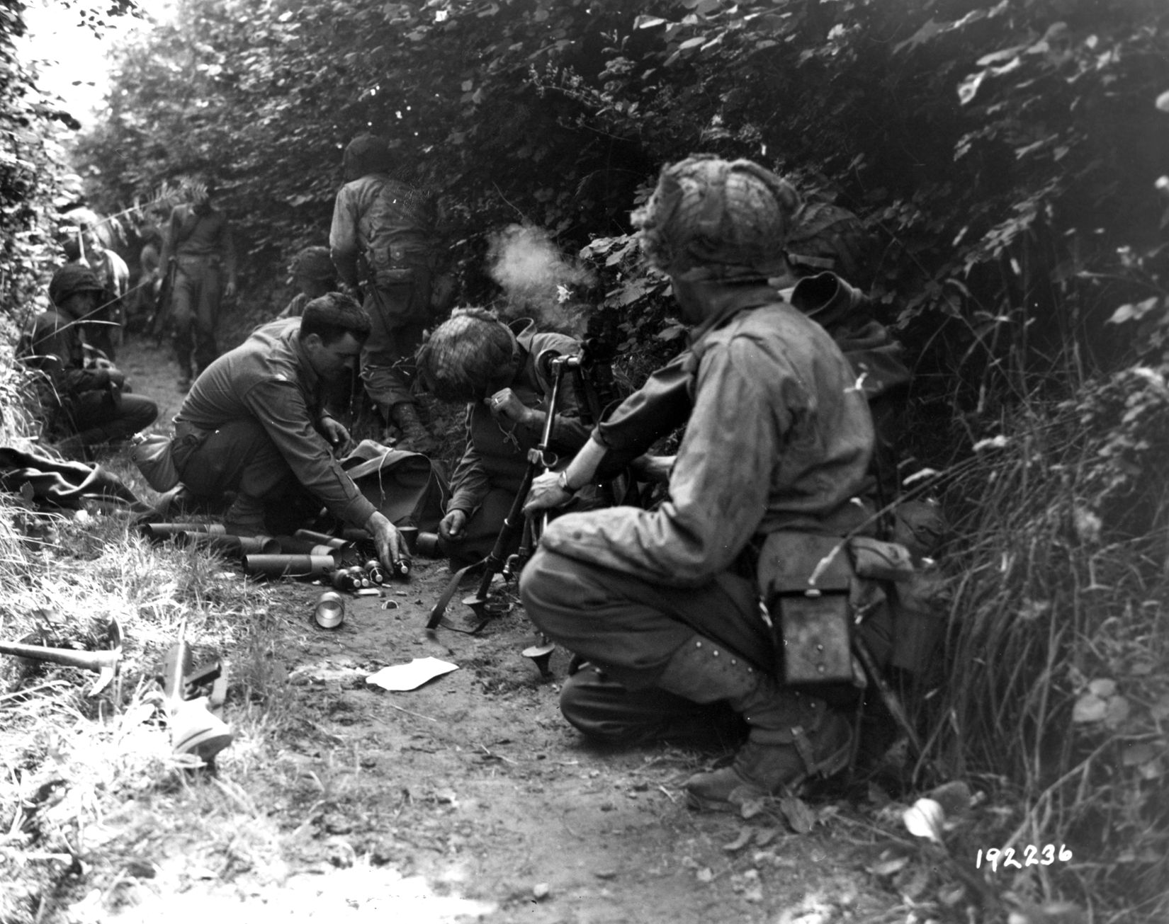 The crew of an American 81mm mortar springs into action during the fighting in Normandy.