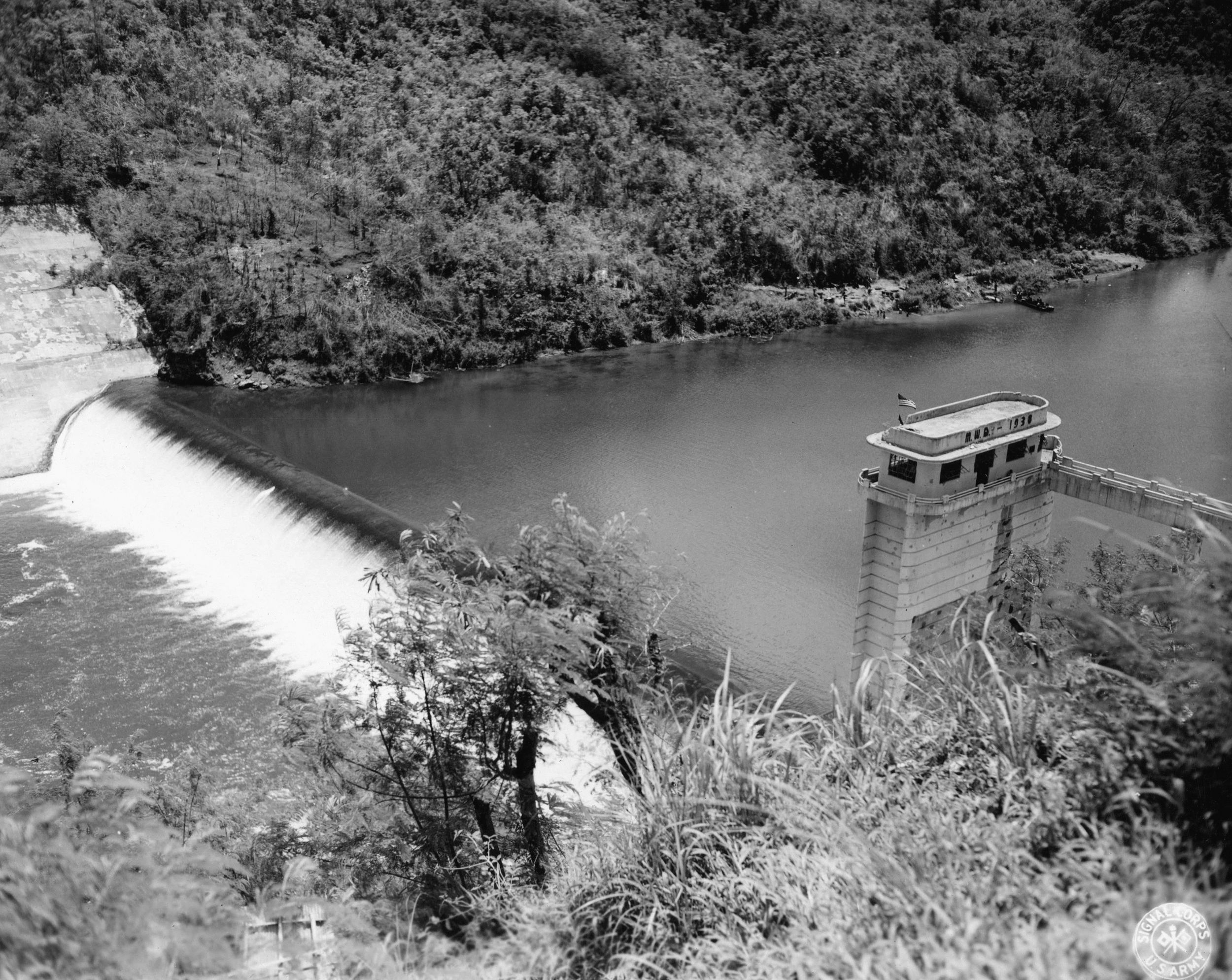 Water rushes through a spillway at Ipo Dam. Capturing the reservoir intact meant that enough water would be available to supply American troops and Filipino civilians in Manila.