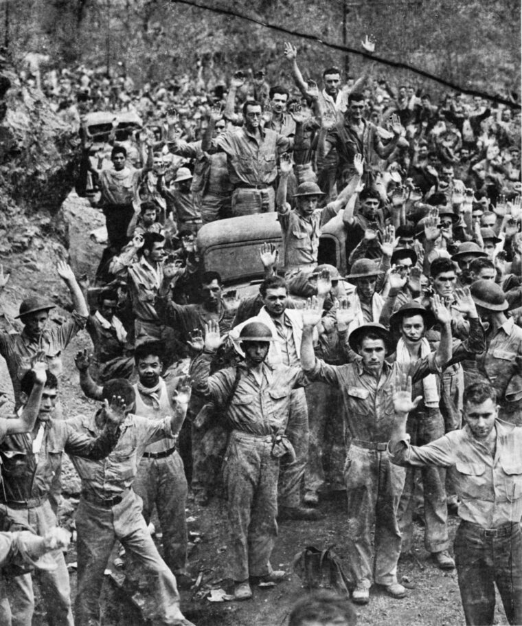 American and Filipino troops raise their hands in surrender after emerging from Malinta Tunnel on the island of Corregidor. The victorious Japanese captured thousands of prisoners during the largest mass capitulation of U.S. military personnel in the nation’s history.