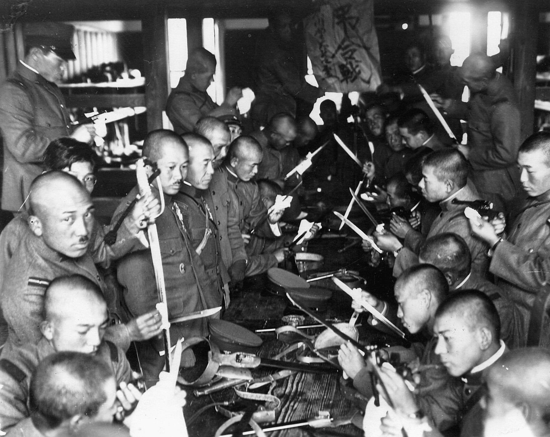 Japanese soldiers check over their weapons and make final preparations as they prepare to land in Manchuria.