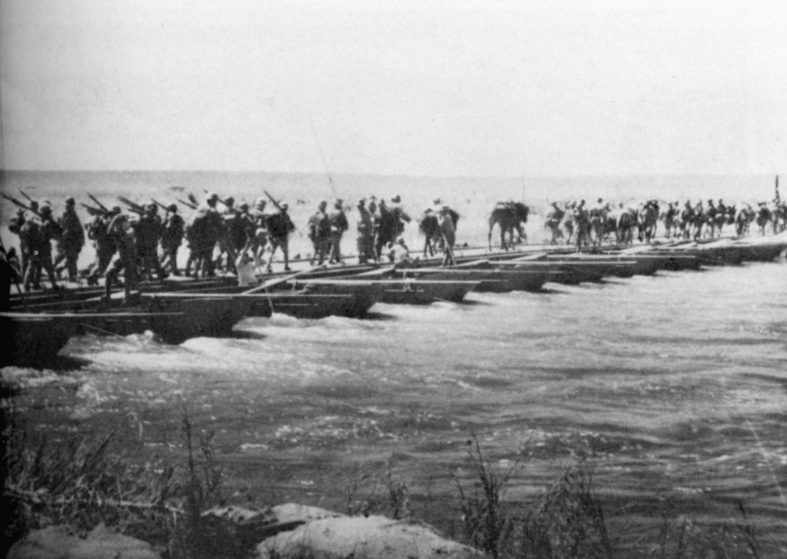 Japanese soldiers take advantage of a pontoon bridge and cross the Halha River on July 3, 1939.