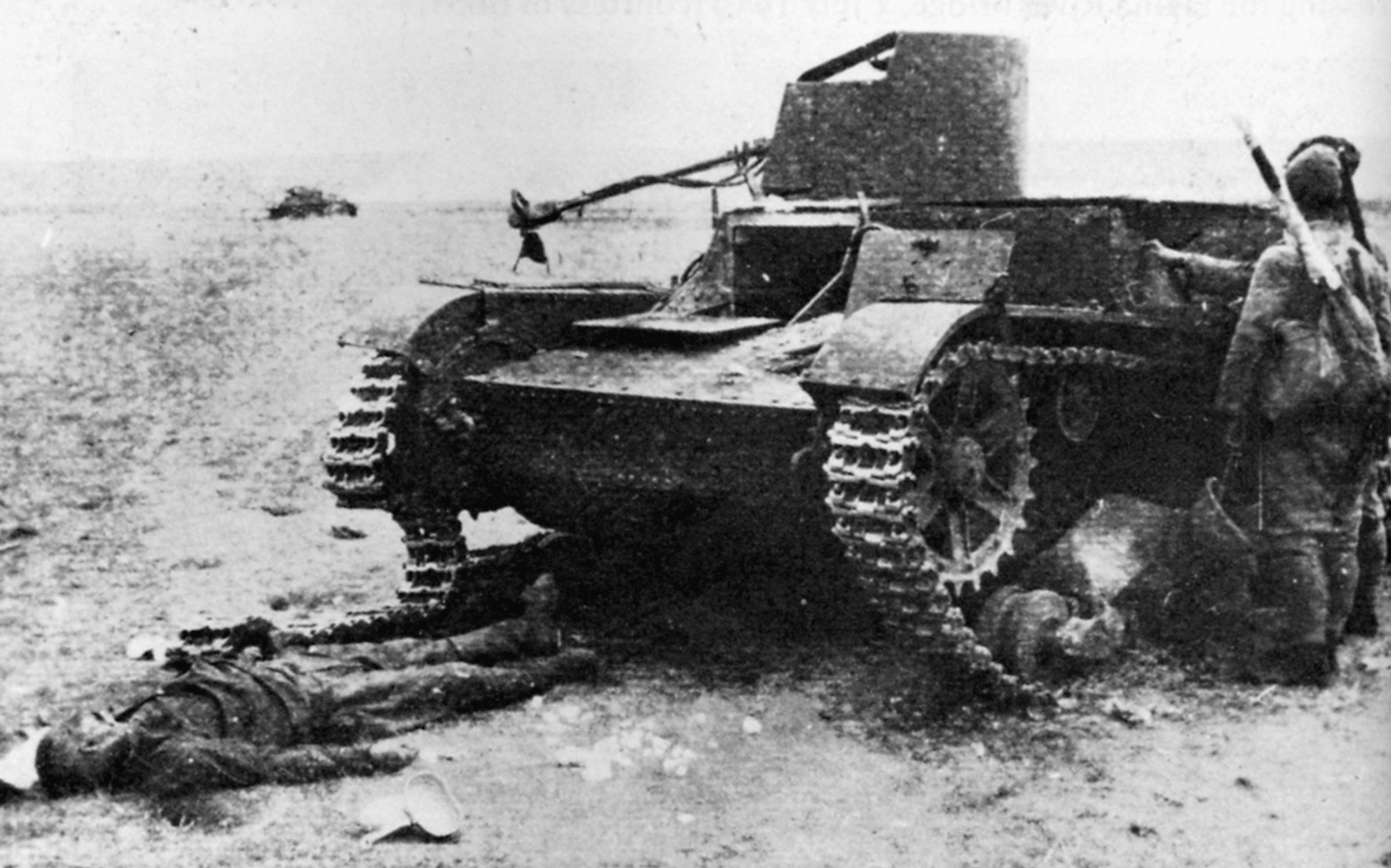 Japanese soldiers inspect a Soviet flamethrowing tank that has been knocked out by well-placed artillery fire. 