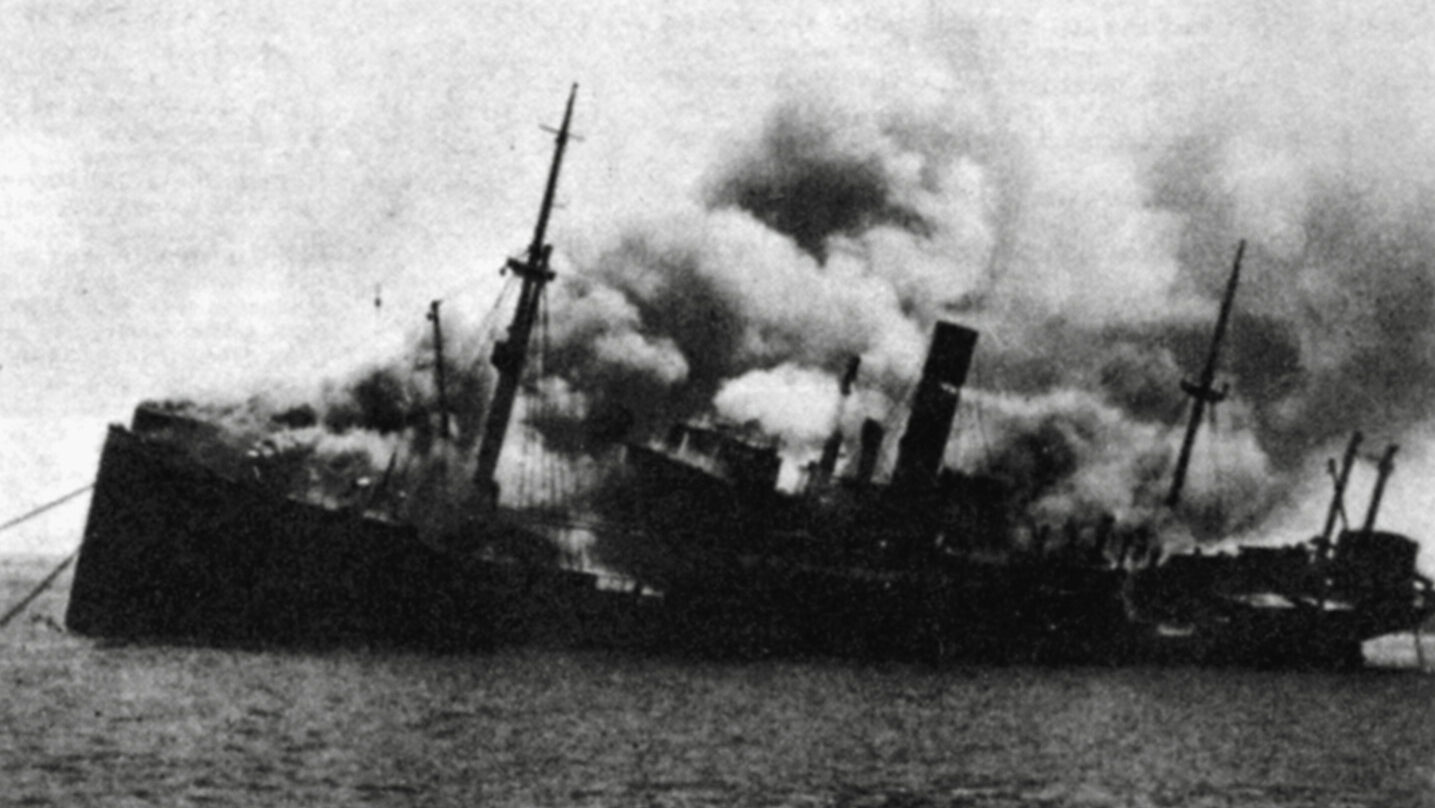 Smoke billows from the German freighter Drachenfels after sustaining damage during a raid by the British.