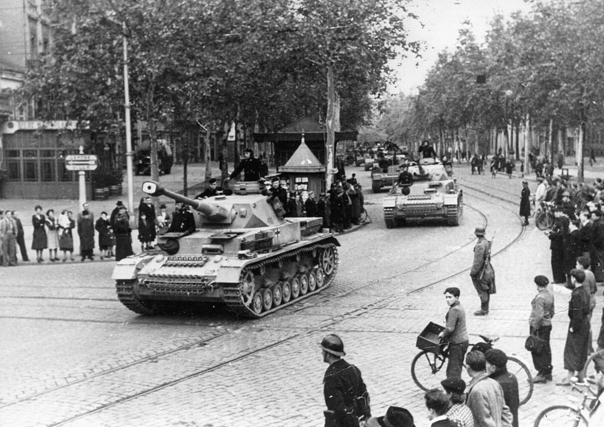 German Mark III tanks parade down a city street in Toulouse, France. 