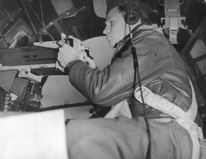 A U.S. airman concentrates as he surveys the skies behind his B-17’s nose-mounted cannon. A head on attack was often favored by Luftwaffe pilots.