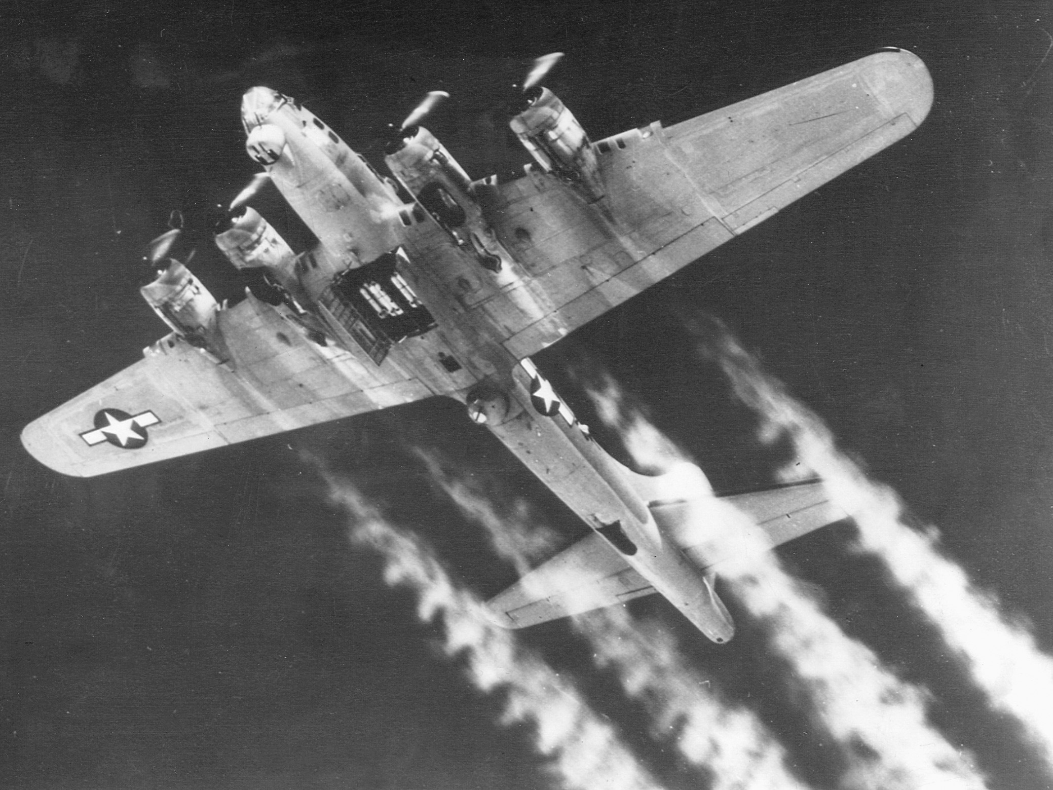 A B-17 streaks across the sky as its bomb bay doors swing open in anticipation of its target.