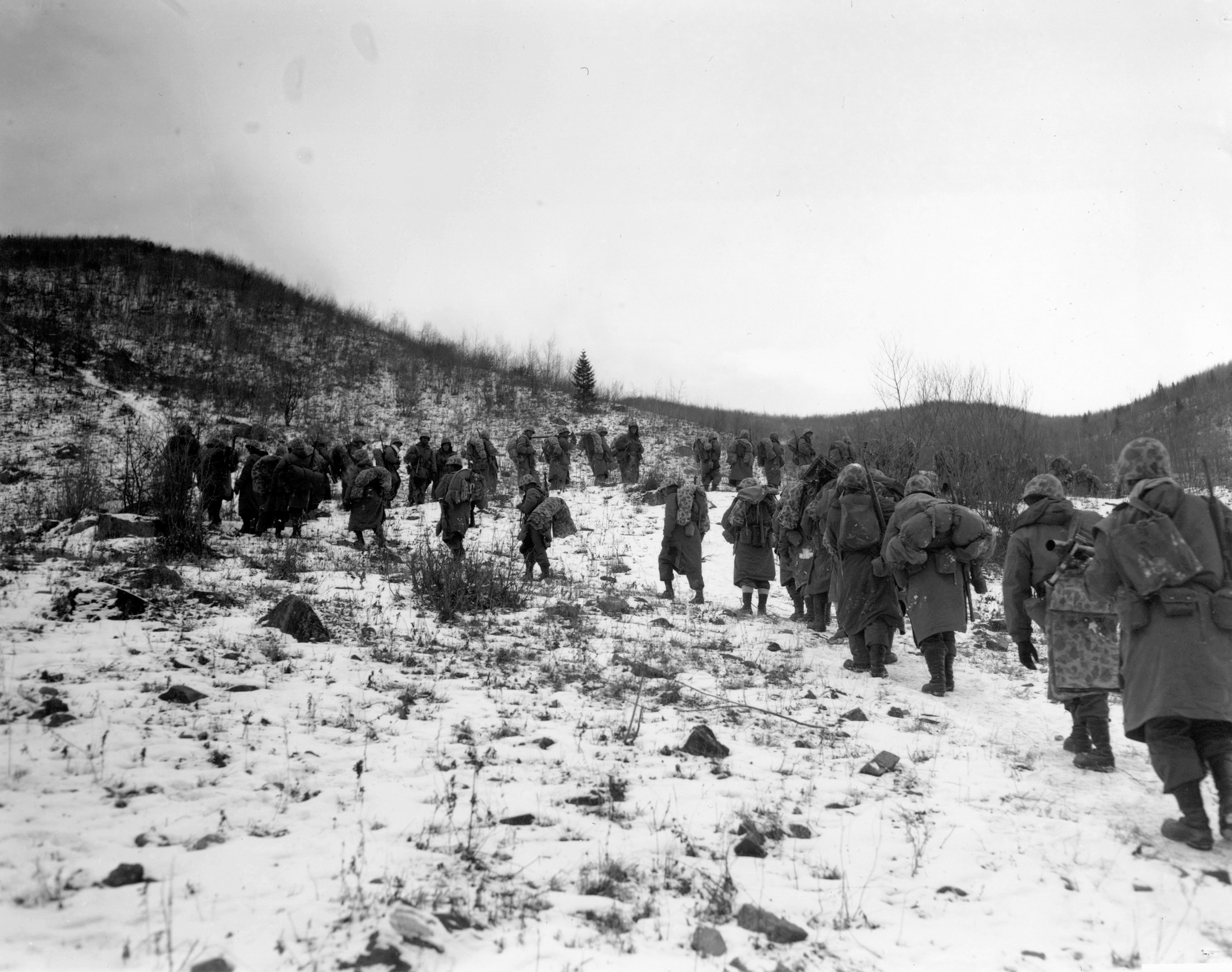 Marines trudge up a hill outside of Yudam-ni. These are probably the men of the 7th Marines moving in relief of one of the embattled perimeter companies.