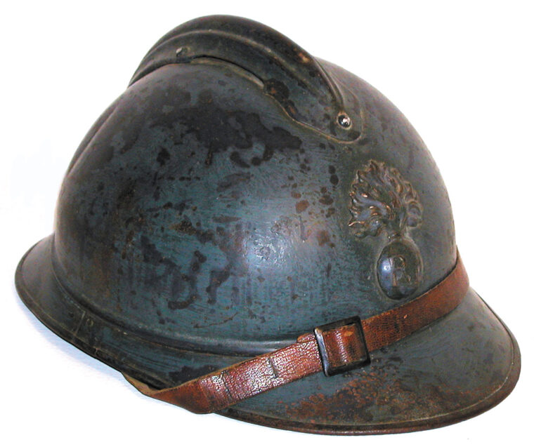 A typical example of the French Model 1915 “Adrian” steel helmet, with early horizon blue paint and flaming bomb badge used for infantry units.