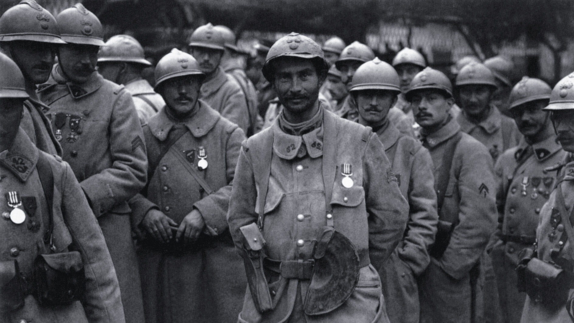 A newly decorated group of French soldiers poses for a photo while wearing the 1915 “Adrian” helmets.